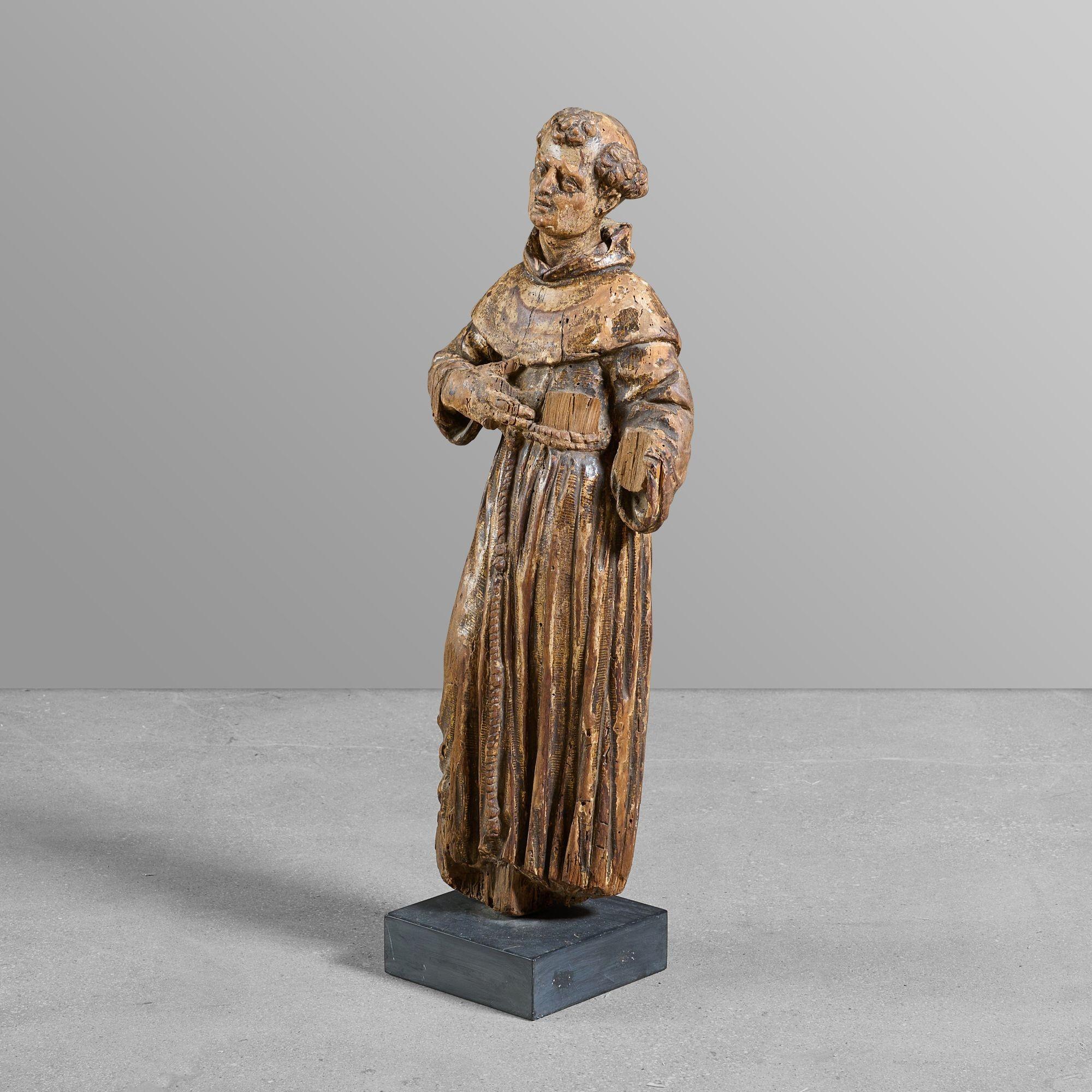 Carved statue of a saint with great patina on newer stand.
