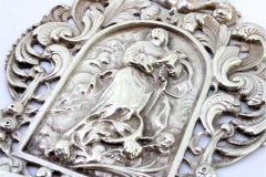 Holy water font w/ the Virgin hovering between angels & floral motifs in relief