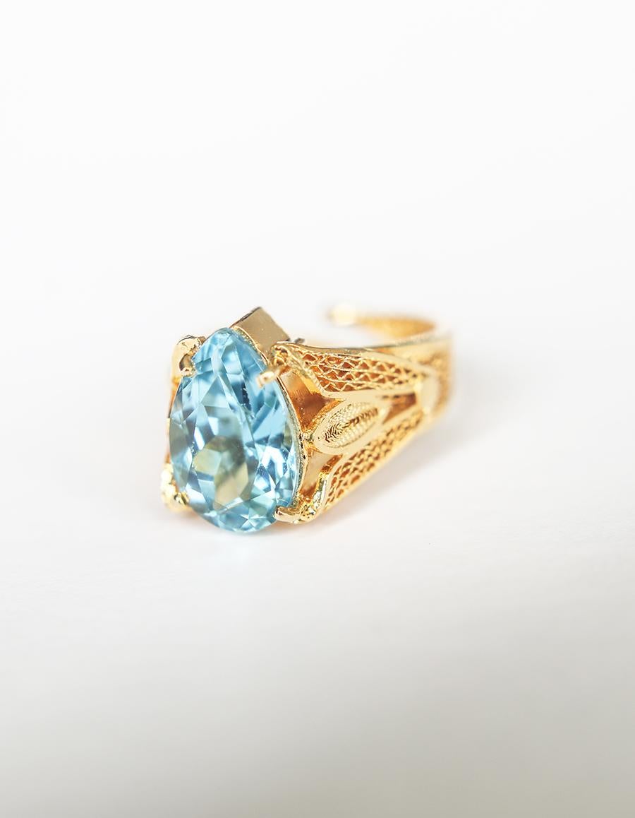 At Holystone we like to take everyday things we see in nature and transform them into something truly enchanting. Our ‘Indira’ ring is made entirely by hand to look like a garden. It's centered with a single 5.6CT blue topaz.

Designed and created