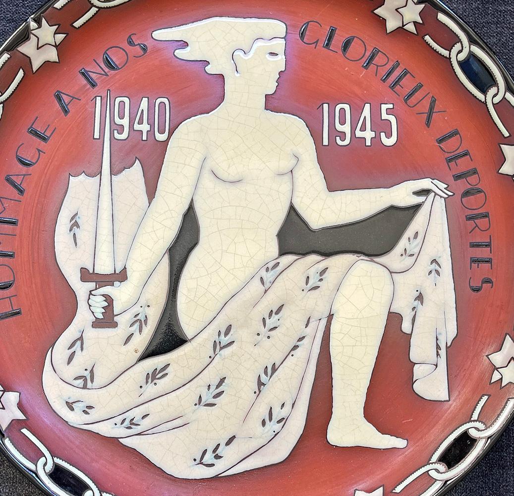 Designed and executed by Ernest d'Hossche, one of Belgium's leading Art Deco artisans in the 1930s and 40s, this very rare wall plate features a nude female figure holding an upright sword, symbolizing Belgium's resistance against the occupying Nazi