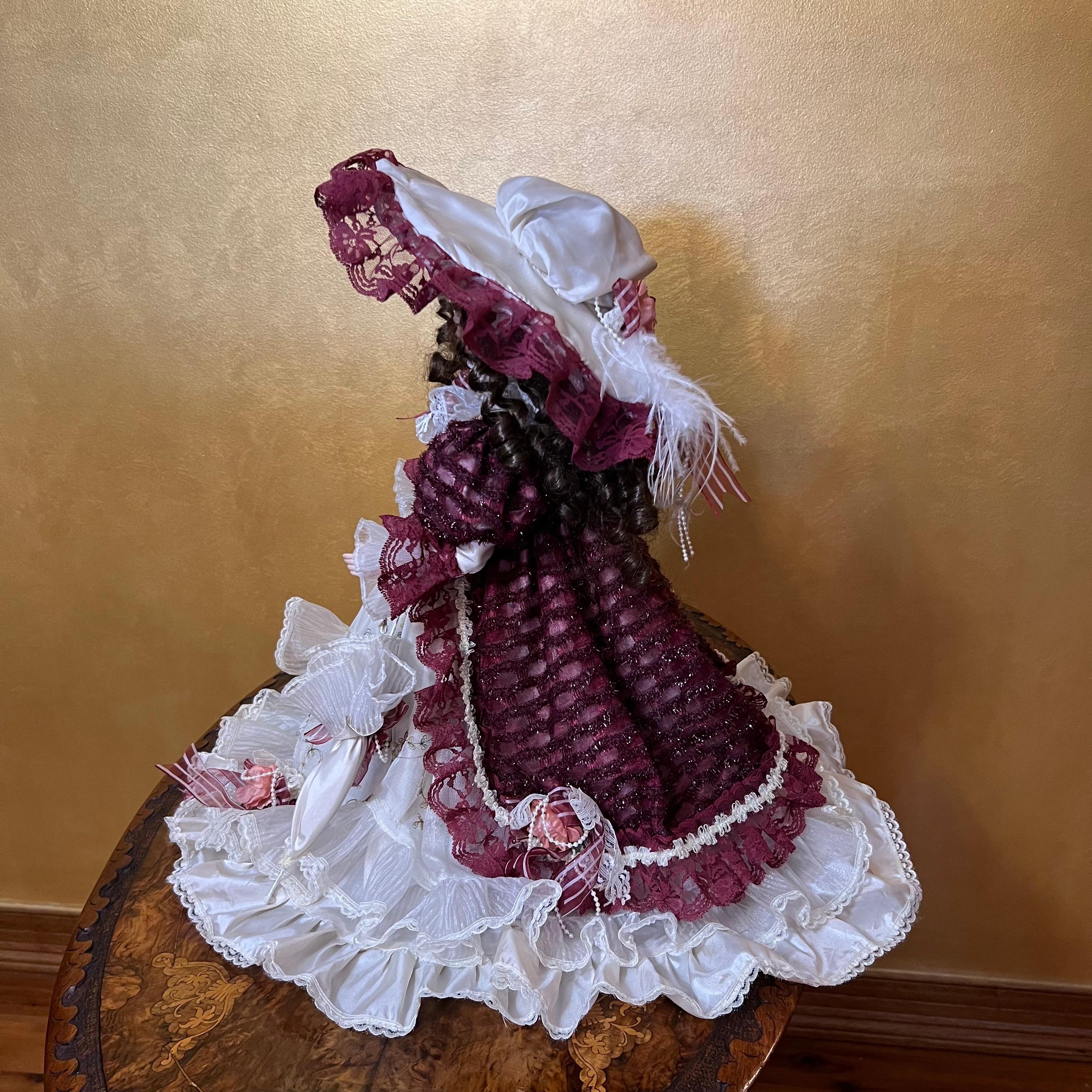 Porcelain face and hands, elegant clothing, she sits on a stand, her name is Isabella.

Material: Porcelain

Measurements: 55cm high, 24cm length, 37cm width

Postage via Australia Post with tracking available