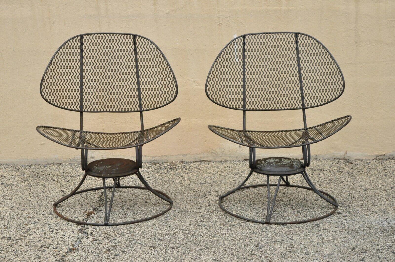 Homecrest Clam Shell Casino Salterini style wrought iron swivel chairs - a Pair. Item features swivel and spring seats, unique clamshell design, wrought iron construction, clean modernist lines, great style and form. Circa mid 20th Century.