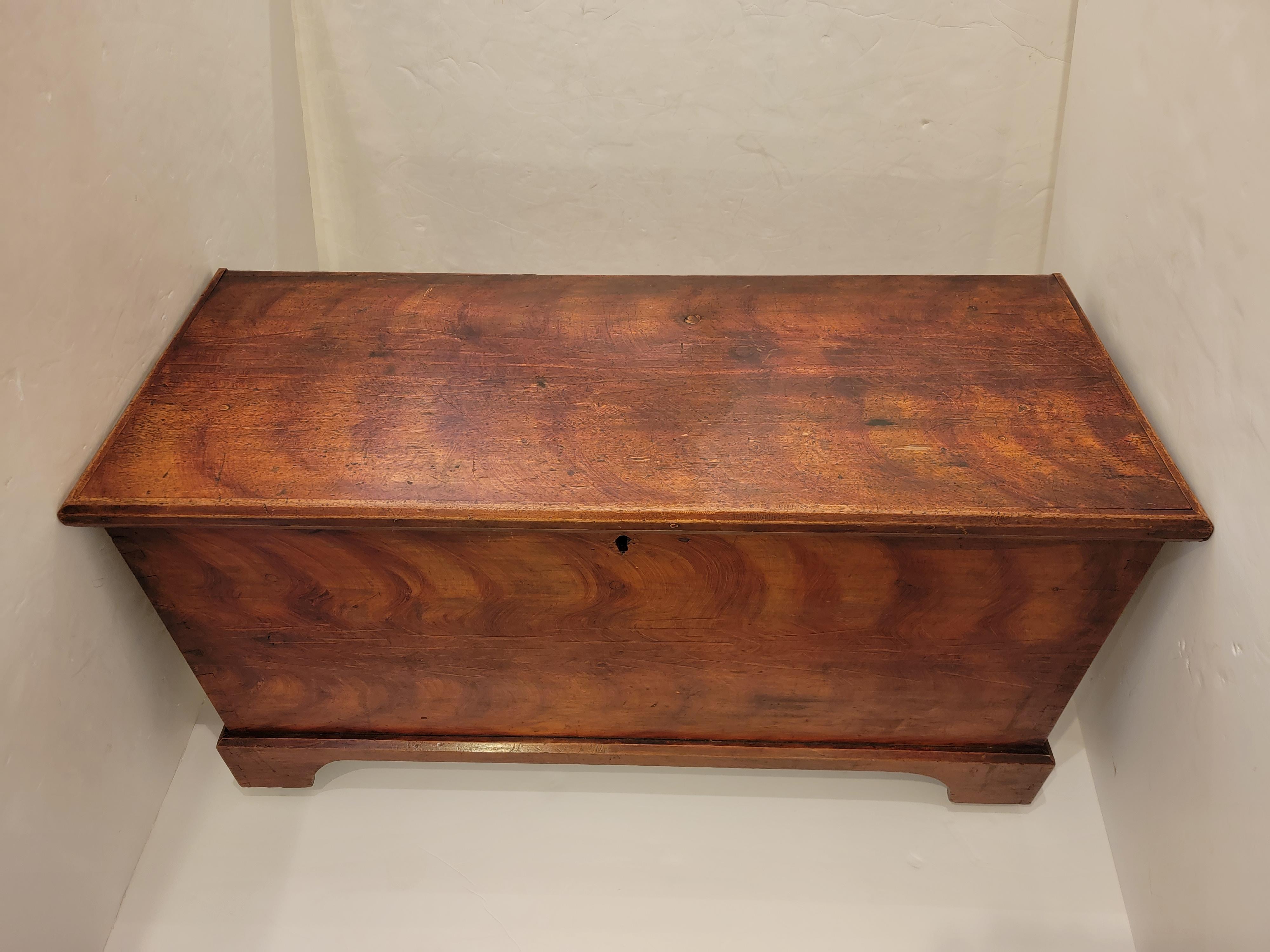 Versatile character rich antique American pine trunk having great storage inside and casters on the bottom. Perfect at the end of a bed. Can also be used as a coffee table.