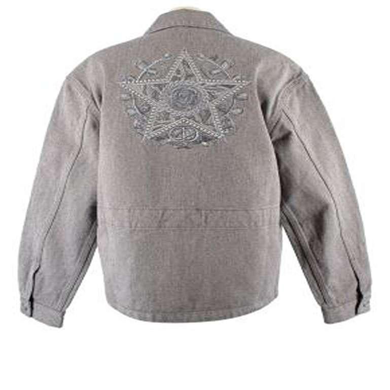 Dior Grey Denim Jacket with Logo Embroidery 
 

 - Grey denim jacket with logo embroidery on the chest and back
 - Silver logo buttons down the centre 
 - 2 chest pockets, one with star logo embroidery in grey
 - Large grey star logo embroidery