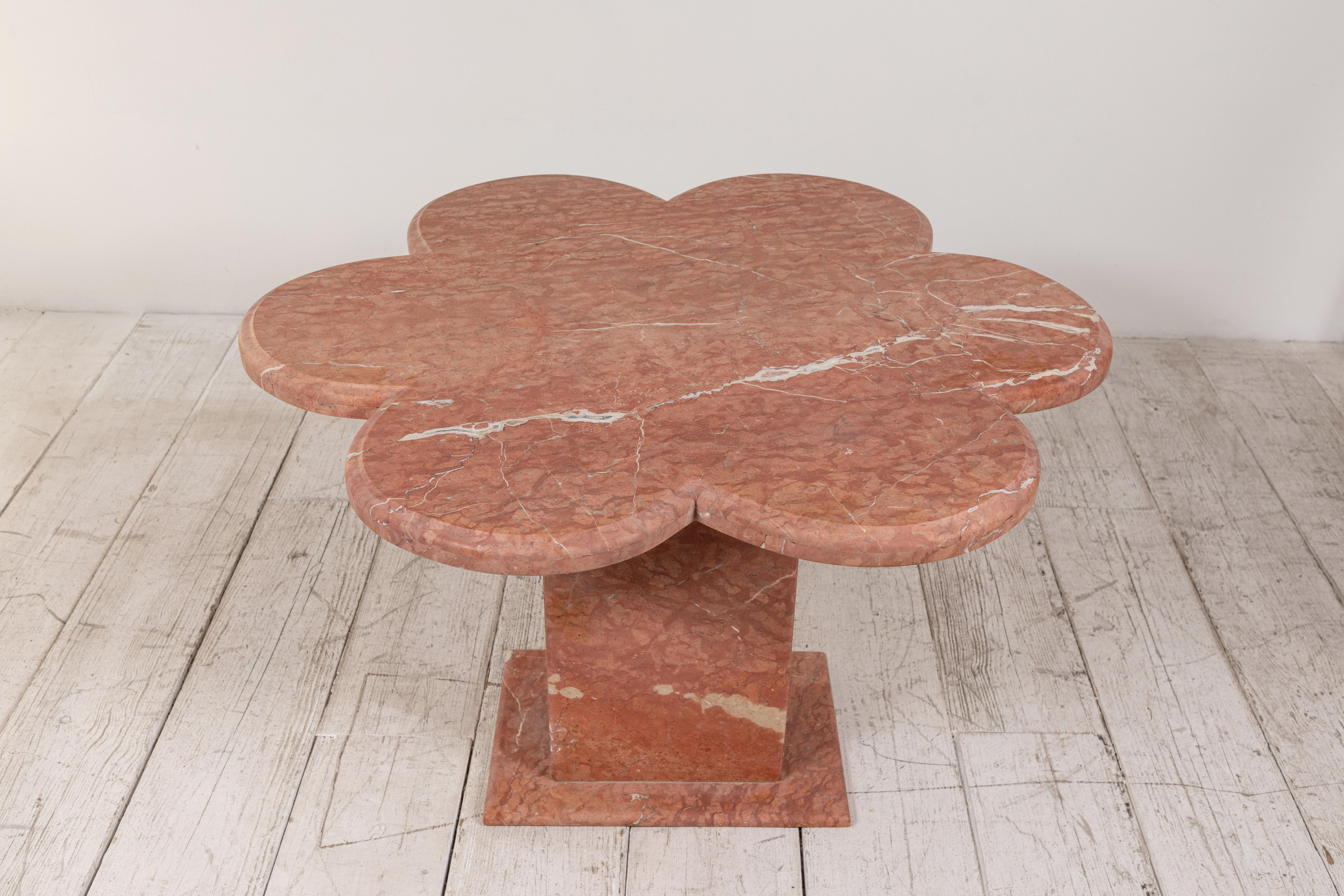 Honed matte quartz scalloped side table sitting on a square pedestal base. The table is fun and whimsical.