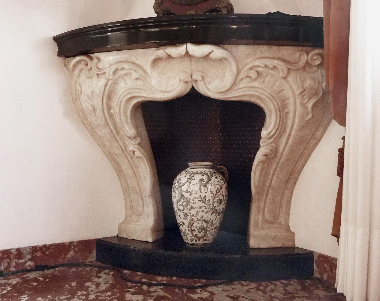 Splendid and rare corner fireplace in Baroque style, France 1940s. Of upper middle-class taste typical of the period characterised by elegant and refined eclecticism. This fireplace imposes itself sinuously in space, expanding from a generously