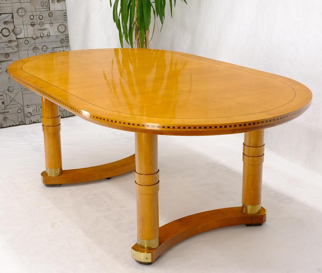 Oval race track shape Henredon dining table in honey amber tone finish with banded and inlayed edge. Brass feet tips or accents.
Two 20