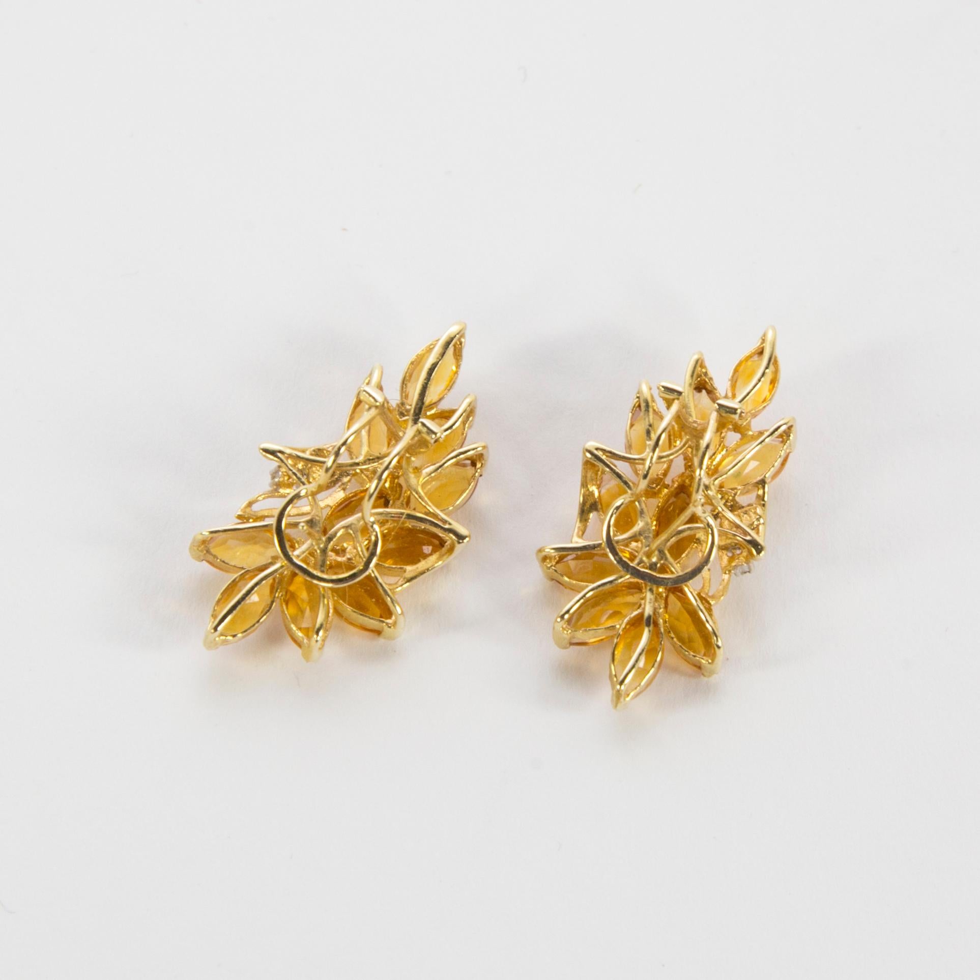 Beautiful pair of Earrings hand crafted in flower spray design each earring set with 10 marquise cut honey topaz stones 20 stones total; each measuring approx. 8mm x 4.5mm; weighing approx.  .50 carat each; approx. 10 carat total weight; accented by