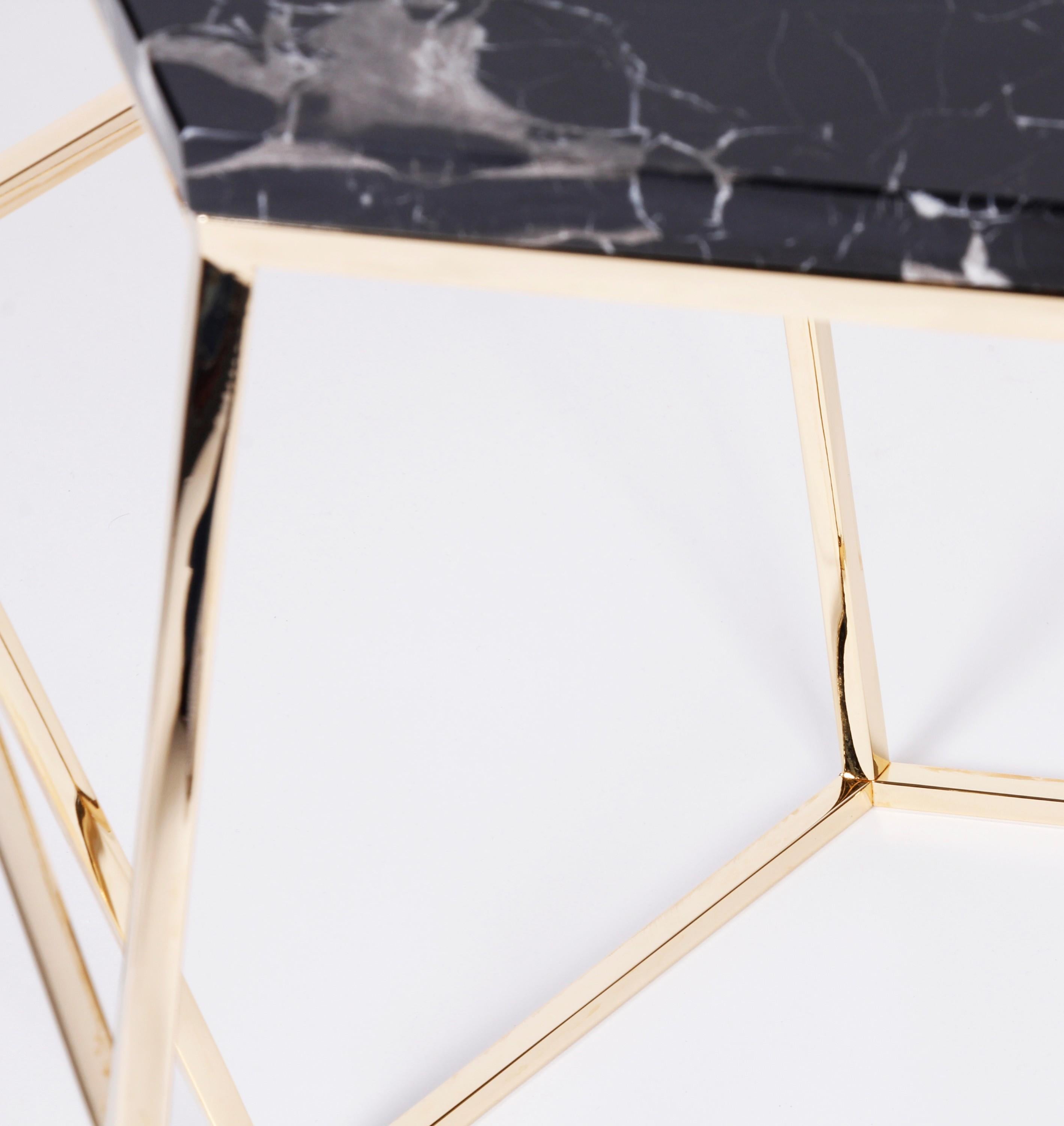 Honeybee side table - Royal Stranger
Dimensions: 52 x 60 x 52 cm
Materials: Black flower marble stone on top of the stainless steel coated in brass structure.

A light metal structure with a touch of gold that supports a shaped luxurious