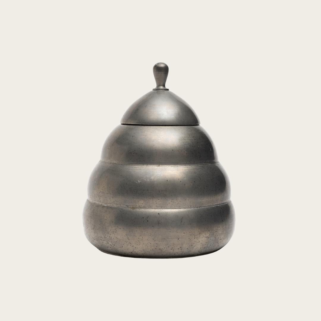 1932, Sweden. This honeycomb-shaped lidded pewter box by Thorild Knutson for Gränna Tenn, his metalwork studio in Sweden. The box features a distinctive cone or honeycomb design and bears the manufacturer’s stamp on the underside.