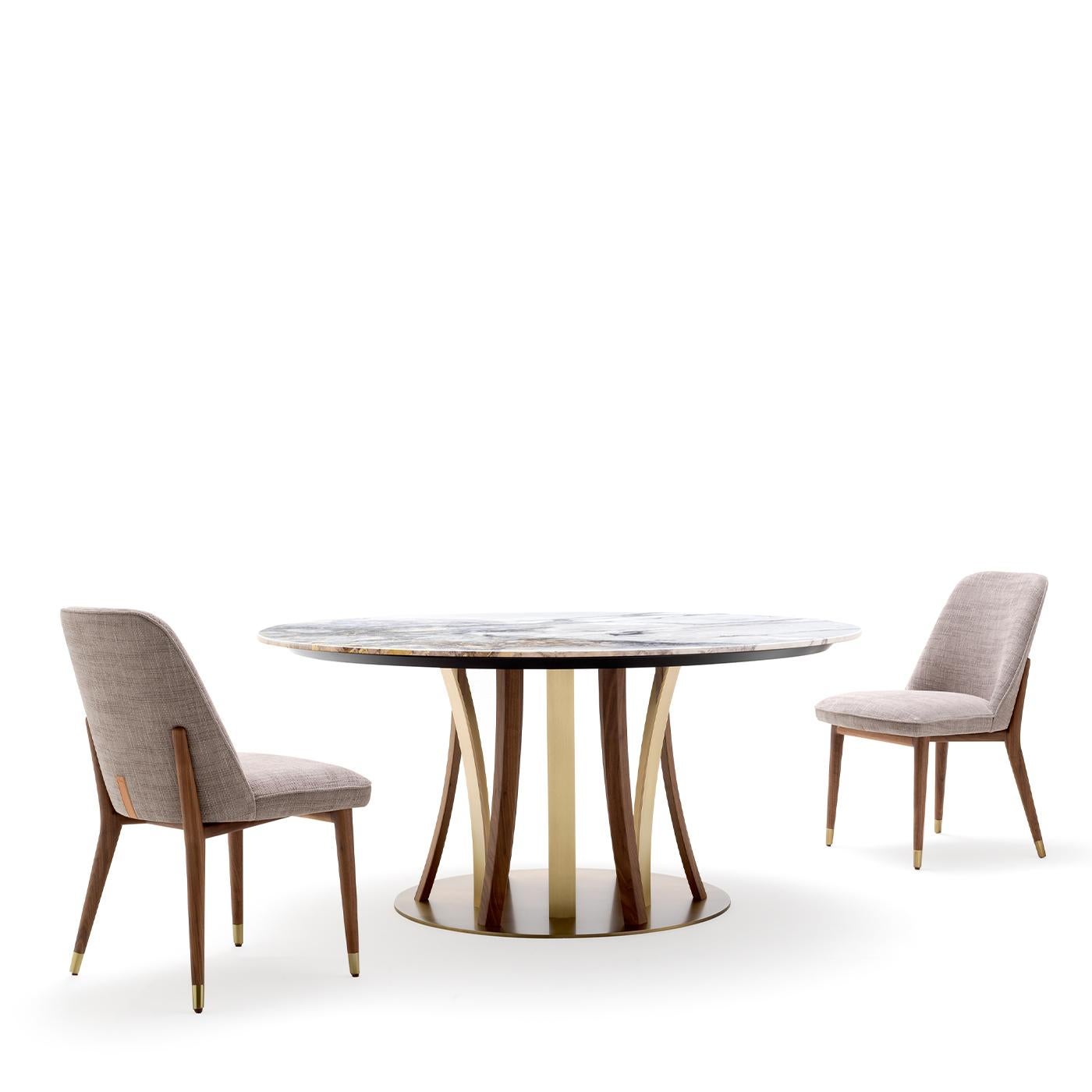 A splendid design by Castello Lagravinese Studio, this dining table will make a refined statement in a modern decor. It features a captivating base boasting a unique interplay of geometric lines composed of American walnut and satin brass-finished