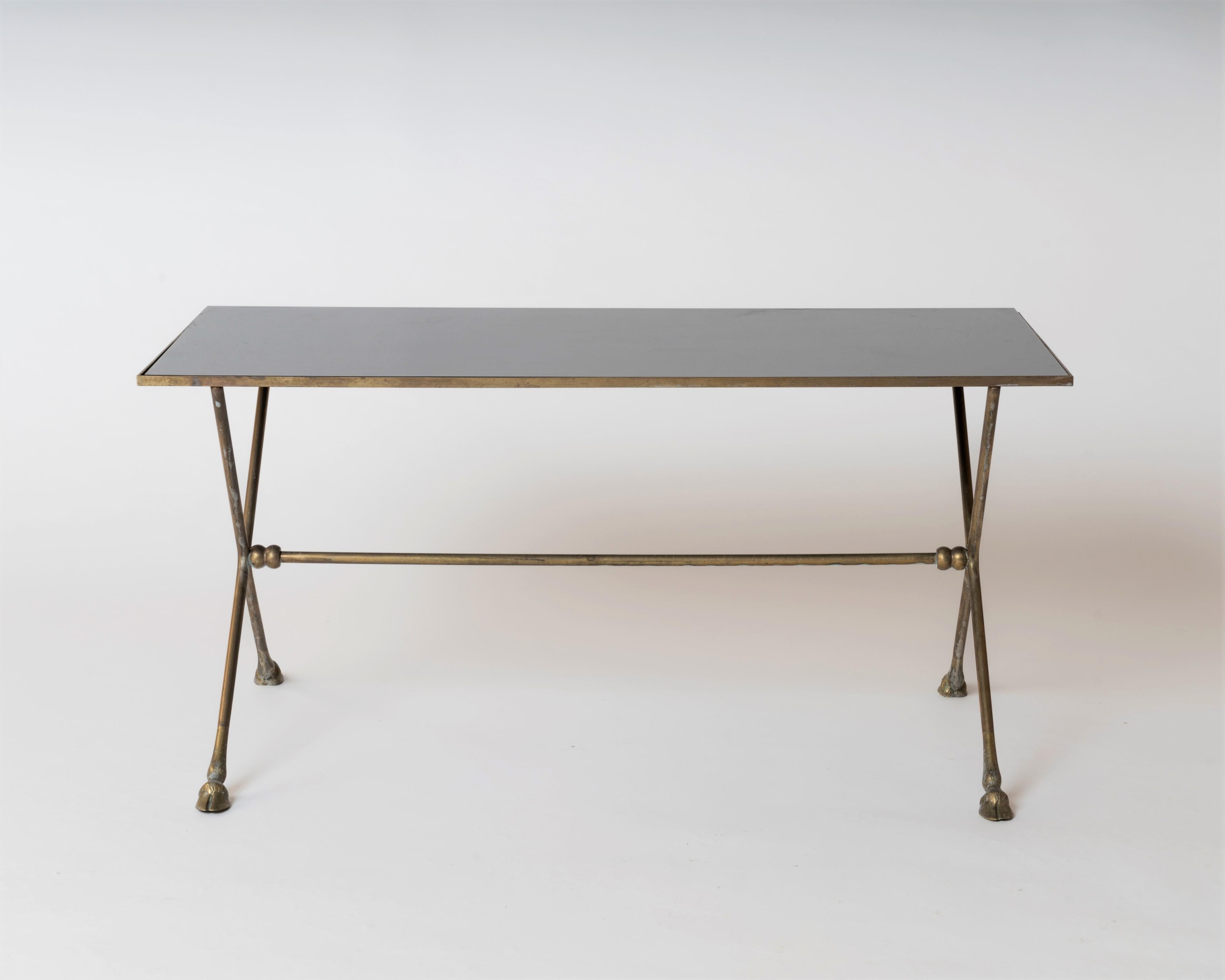 Elegantly neo-classical  bronze table by Maison Ramsay with hoof feet and black opaline top. X-shaped legs with intermediary 