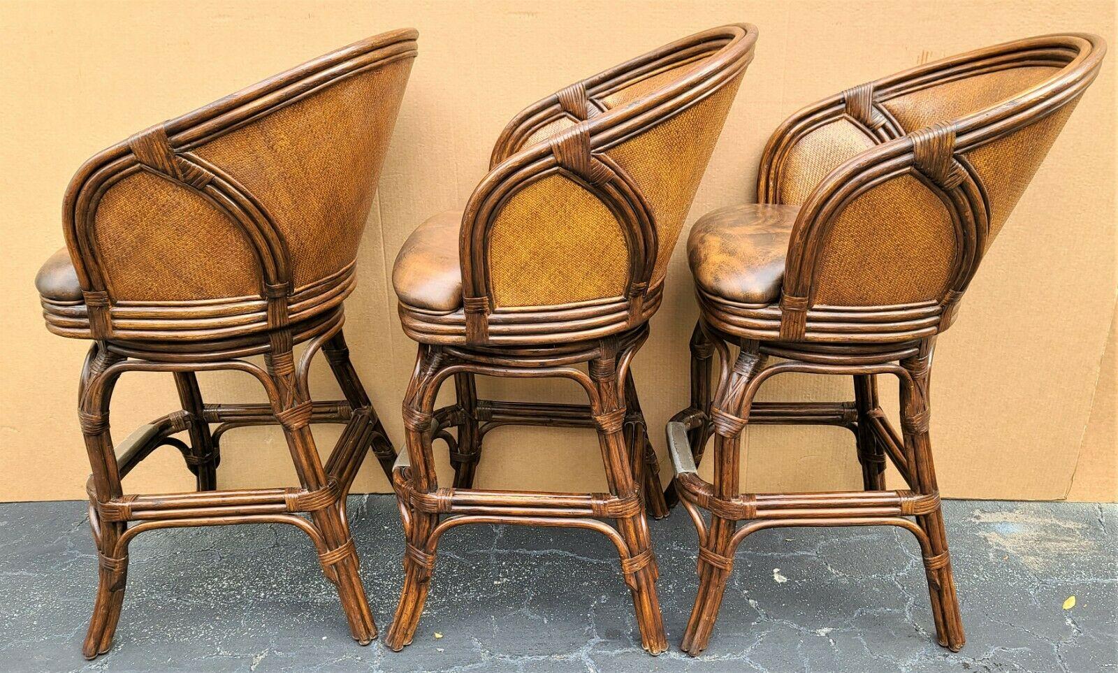 Offering one of our recent Palm Beach Estate Fine Furniture acquisitions of a
Set of 3 Hooker bamboo rattan wicker leather swivel barstools

Approximate measurements in inches
43.5