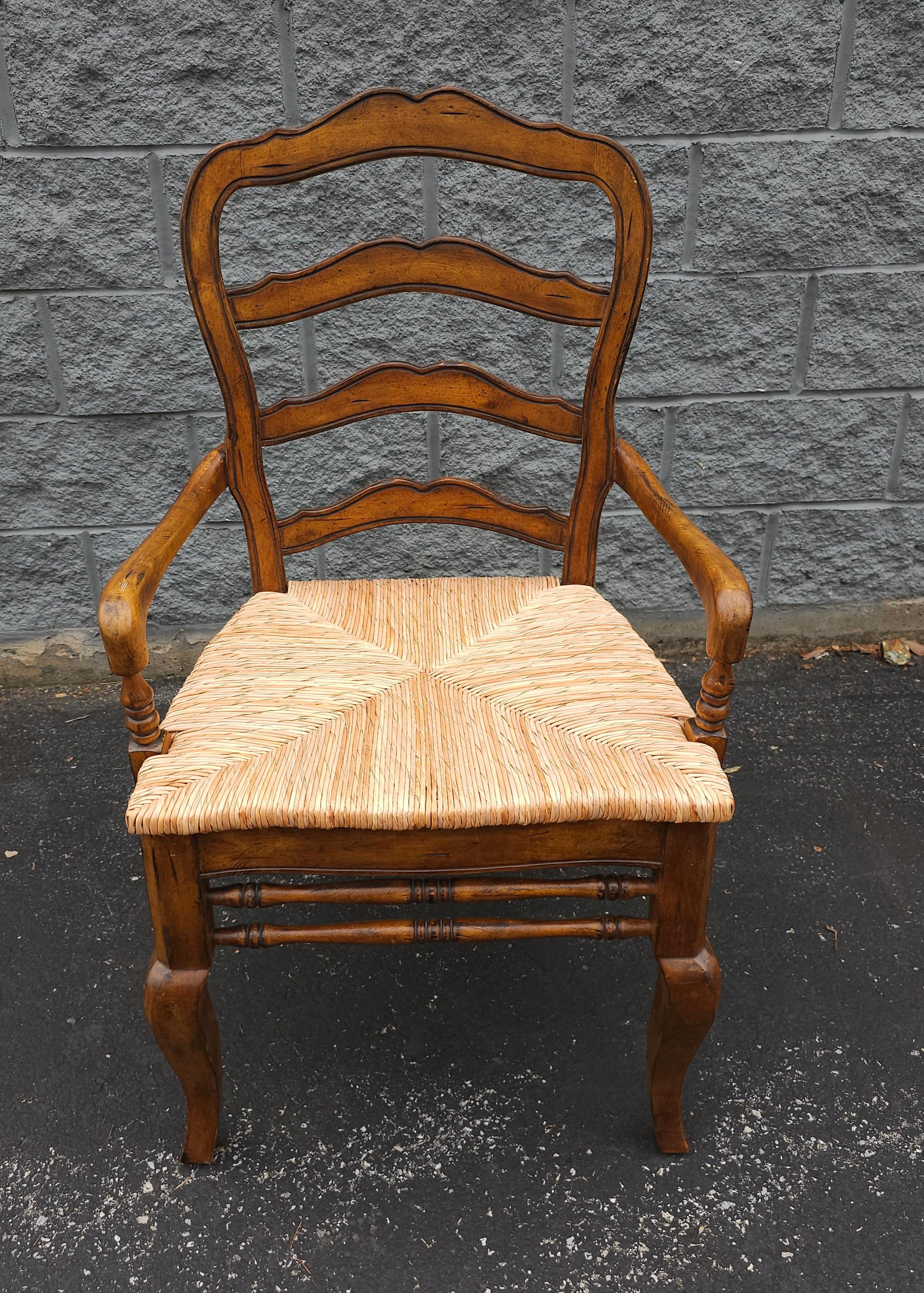 A 21 century Hooker Furniture Co Provincial Style ladder back and Rush Seat Arm Chair in mint condition. Measures 23.5