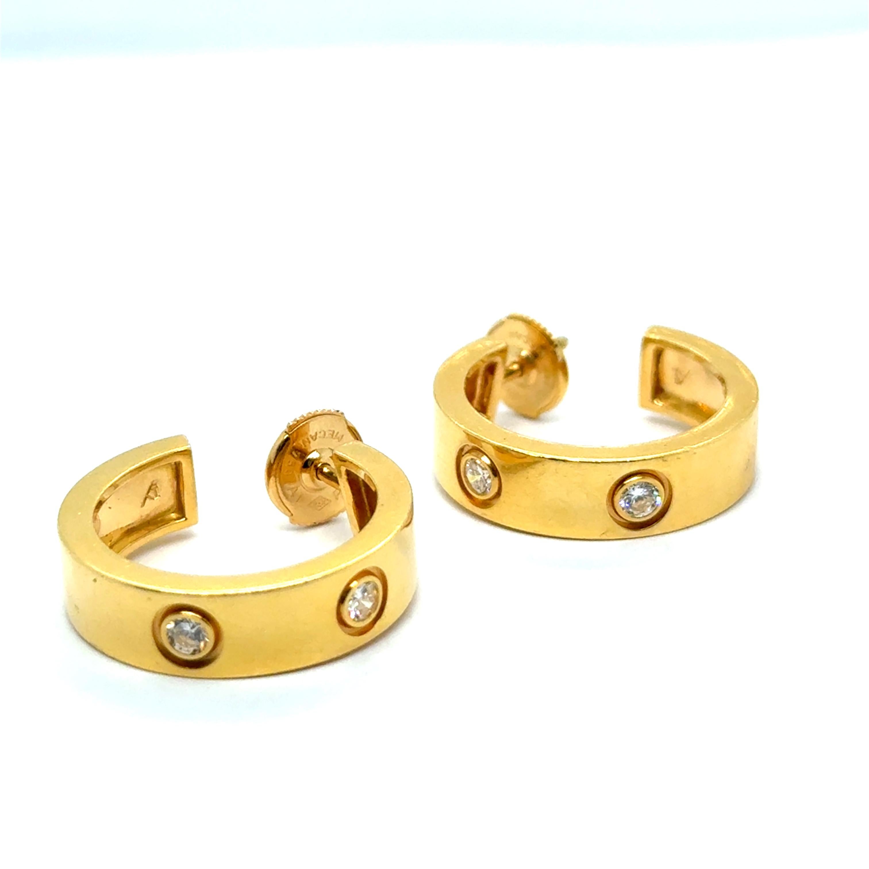 A timeless masterpiece from famous Cartier House, these exquisite hoop earrings are part of the iconic Love Collection. Crafted in solid 18 Karat yellow gold, they feature six round brilliant-cut diamonds, totaling approximately 0.36 carats. The