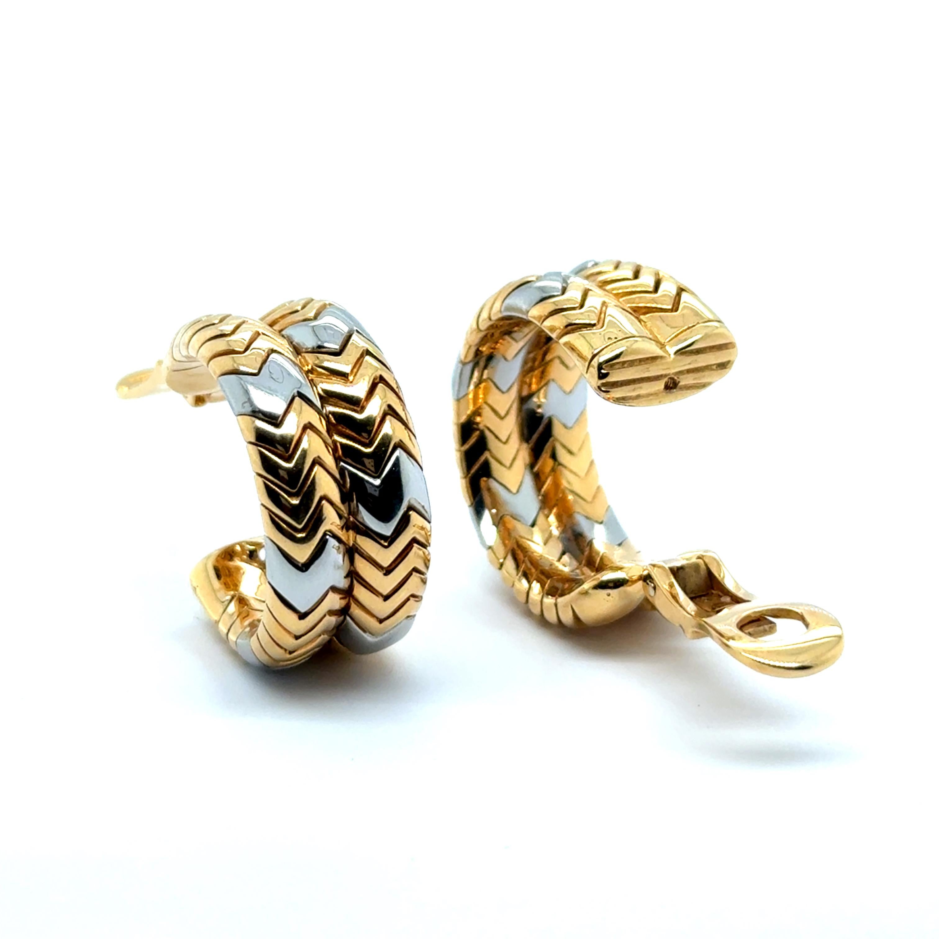 These Bvlgari Spiga Collection earrings are crafted in 18 Karat yellow and white gold, featuring the signature chevron pattern inspired by the timeless wheat motif. With a perfectly engineered clasp, they offer a secure and comfortable fit. The