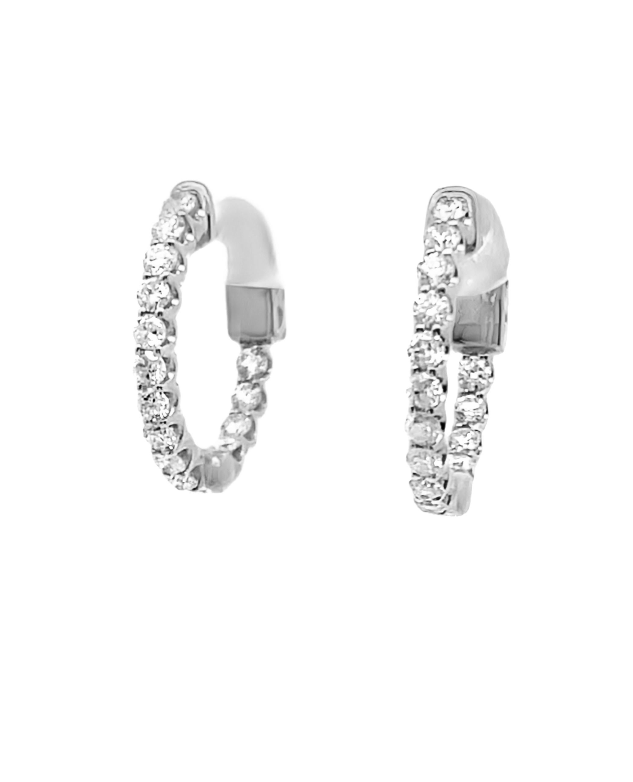 Pair of 14K white gold hoop earrings with round brilliant-cut diamonds weighing 0.83 carat total.  

- Earrings are 18mm in diameter
- Diamonds are G/H color, SI clarity