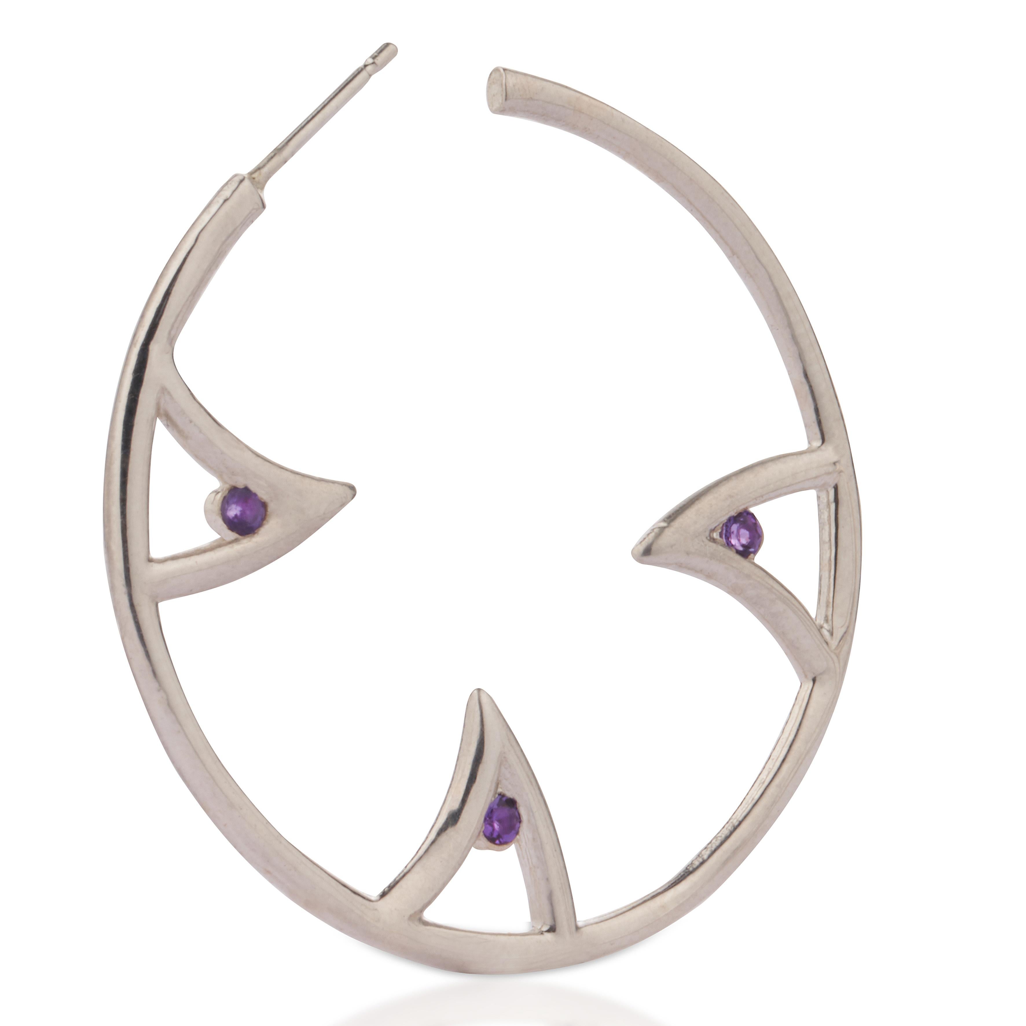 A pair of hoop earrings in polished sterling silver, set with 6 amethyst stones. A playful alternative to the traditional hoop earrings, with a boho-chic twist. 
Seen on Sibley Scoles.
Gemstones: 3 amethyst stones per earring (2.20 mm round, 0.36