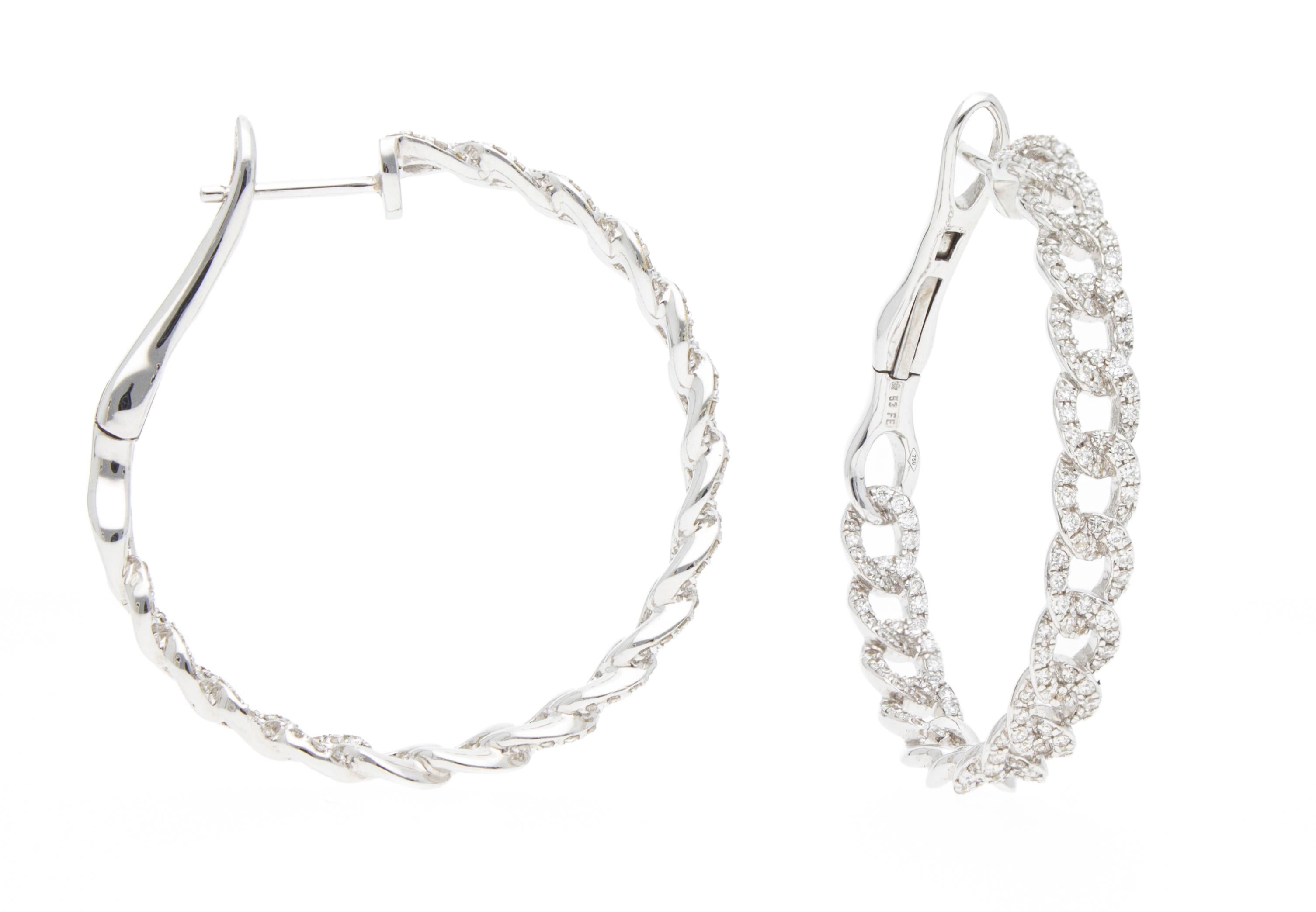 The earrings are in the shape of a circle.
The earring design is a circle shaped groumette chain. 
The links of the chain are set with 0.79 ct of diamonds. 
The diamonds are both on the outside of the hoop and on the inside, to allow the earrings to