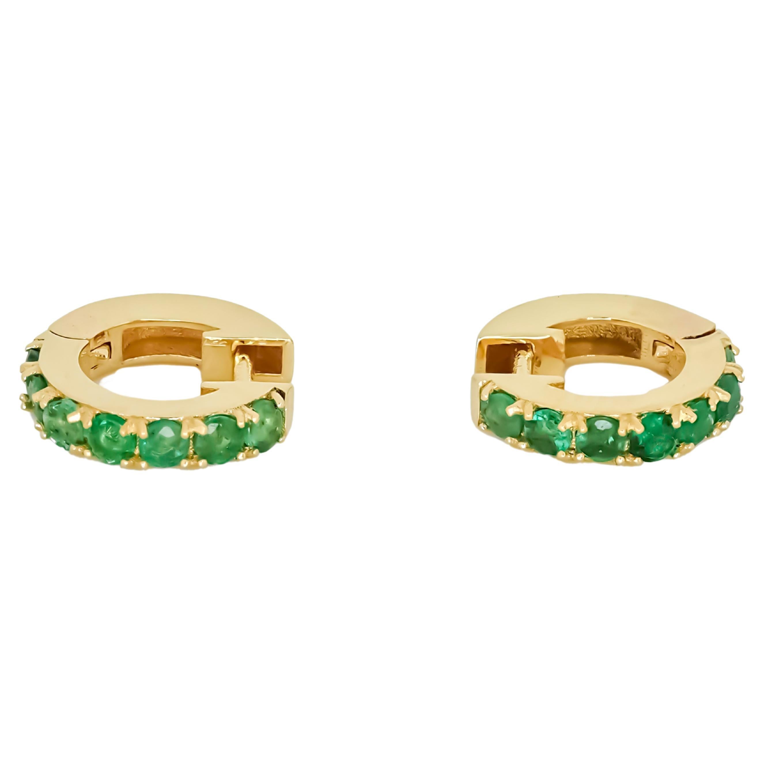 Hoop Earrings with Emeralds. Huggy hoop emerald earrings in 14 Karat Gold