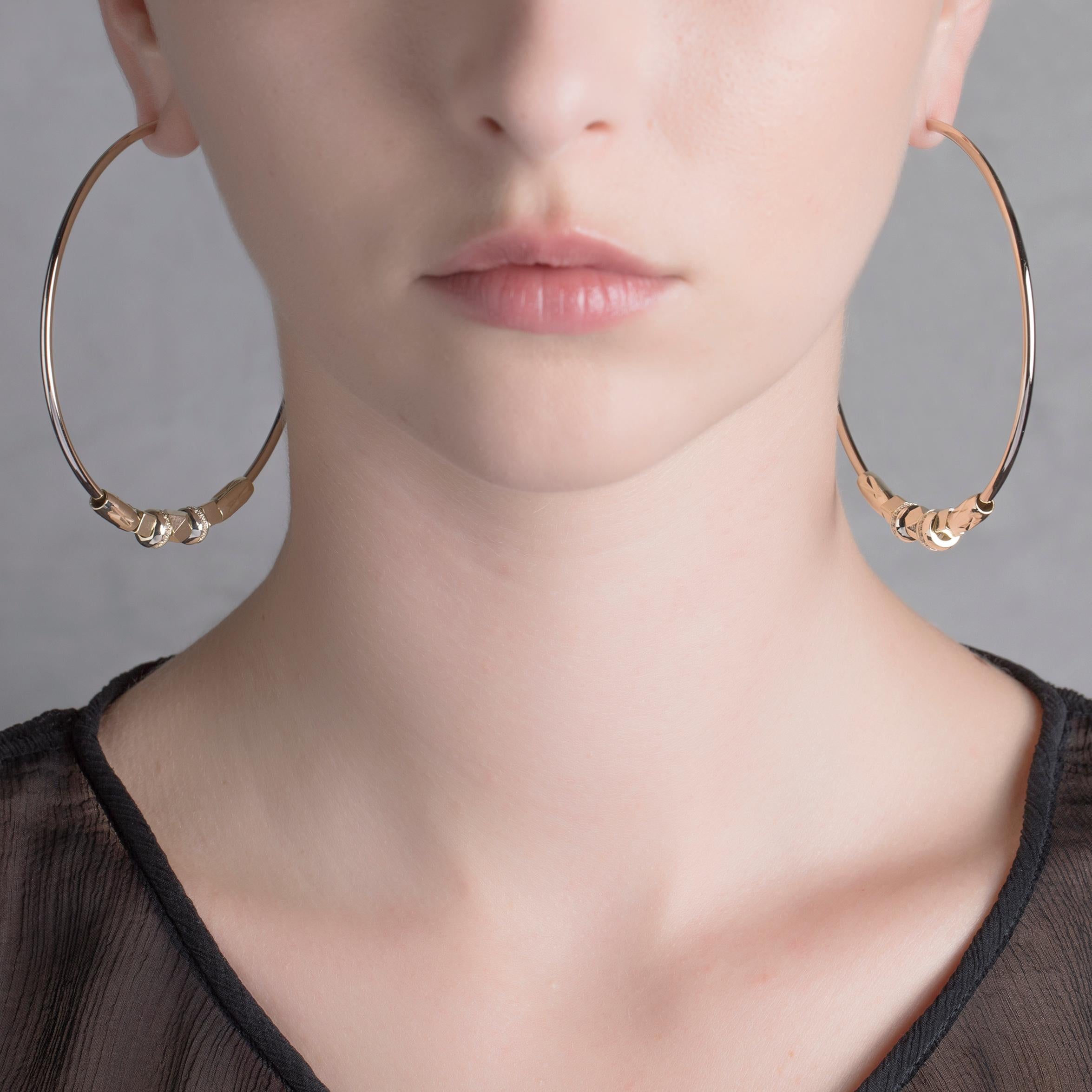 Classic hoops are reimagined by IOSSELLIANI to create these reversible earrings that are designed with diamond cut brass beads embellished with cubic zircons all around.
The pair features a choice of of stoppers in three different materials: a