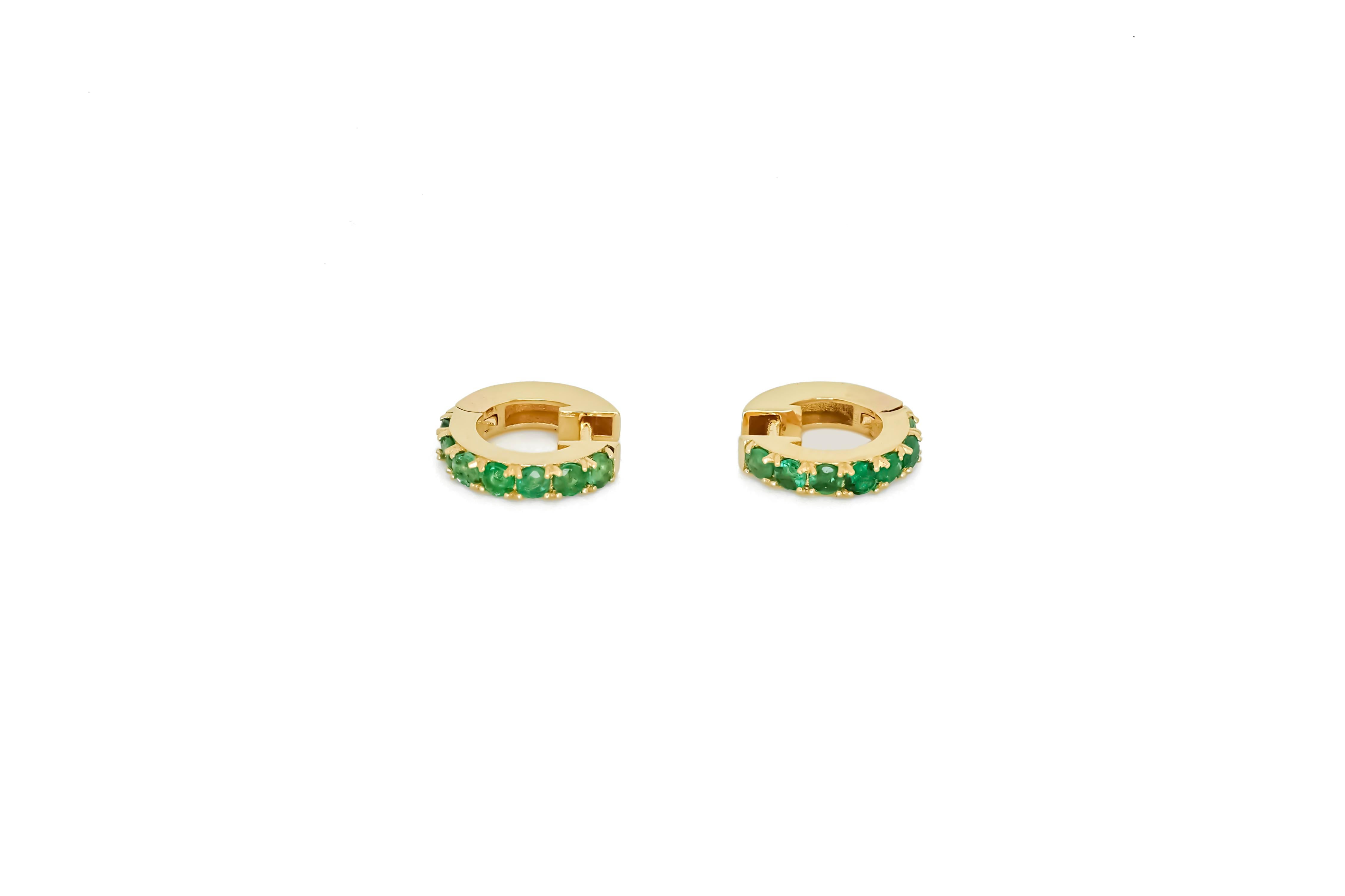 Modern Huggy Hoop Earrings with green gems in 14k gold  For Sale