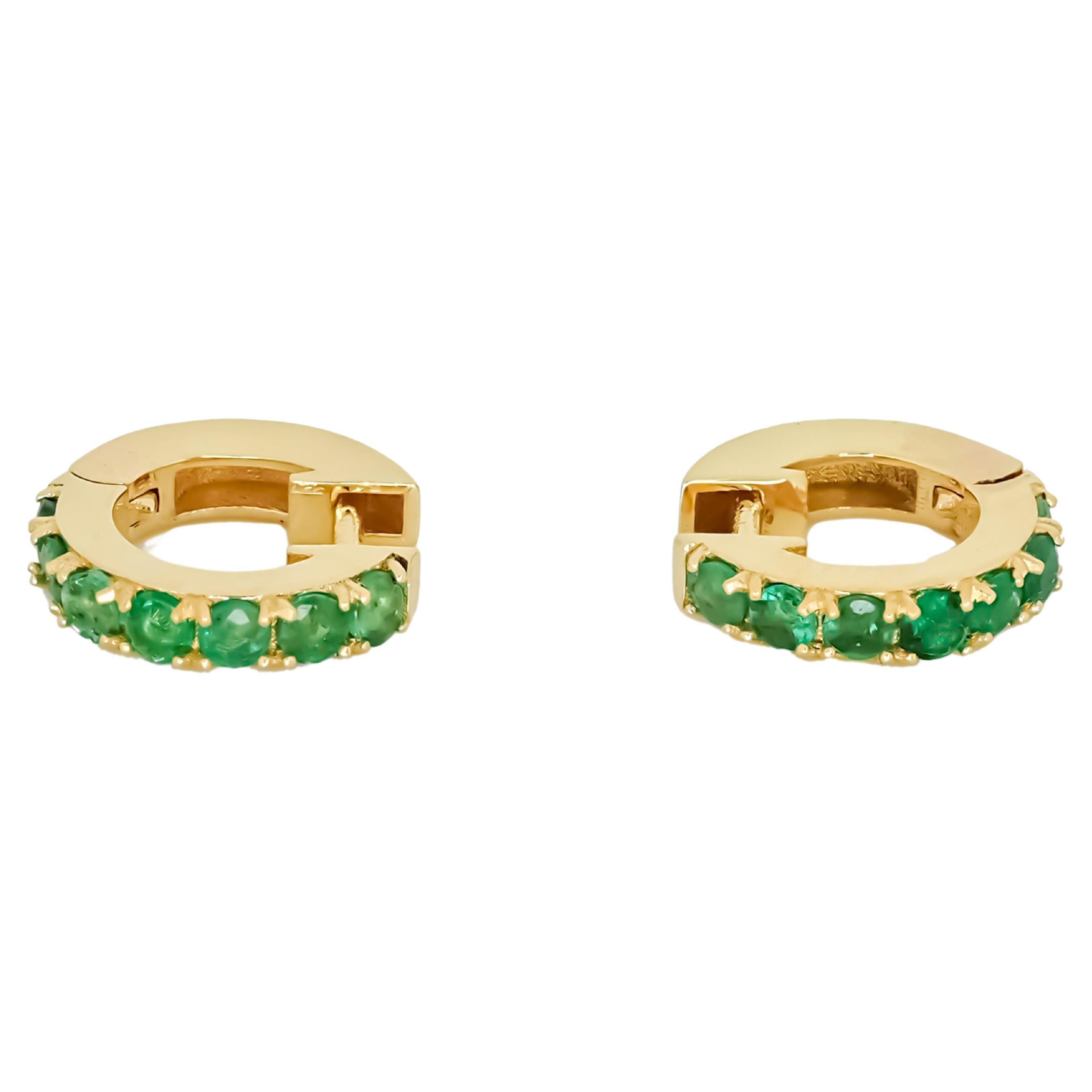 Huggy Hoop Earrings with green gems in 14k gold  For Sale