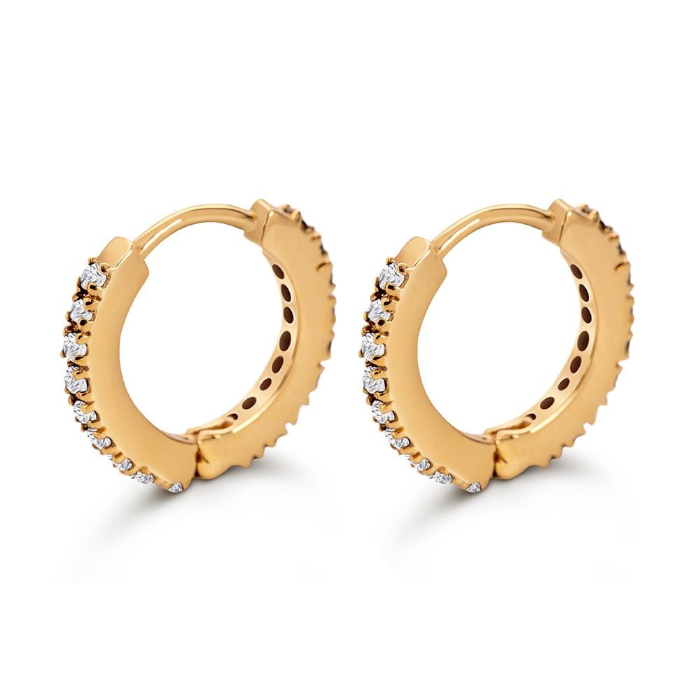 Unisex small hoop earrings in 9k recycled yellow gold, set with natural white diamonds. You can wear them traditionally in two ears or layer in one if you have multiple piercings. They are also perfect for a mix and match style. Sold as a pair. For