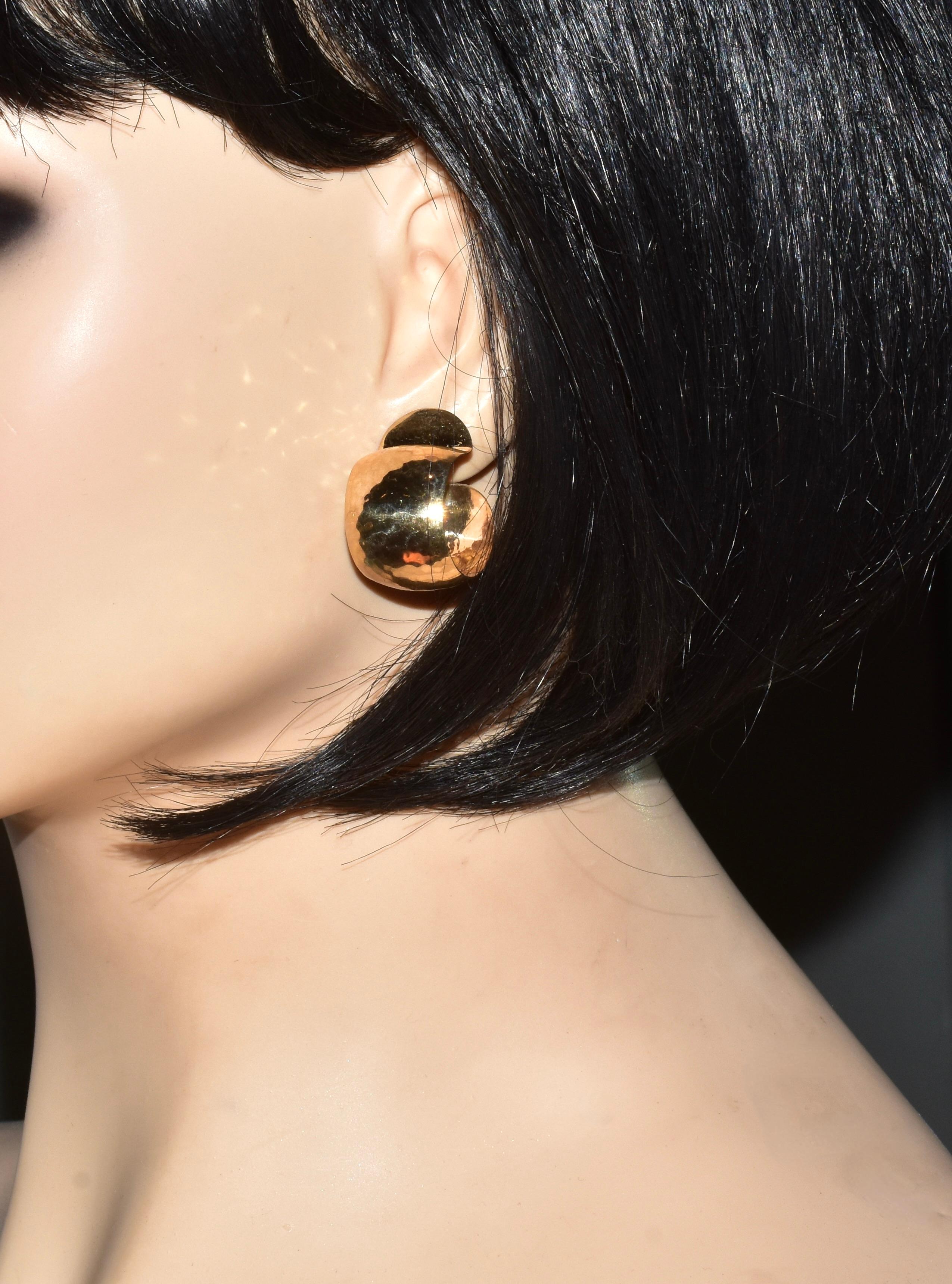 Hoop style earrings with a hand hammered, bright polished yellow gold.  Easy to wear, lightweight so they will not pull down on the ear lobe weighing 6.59 grams, these earrings are for a pierced ear.  Curling up toward the back, these earrings are