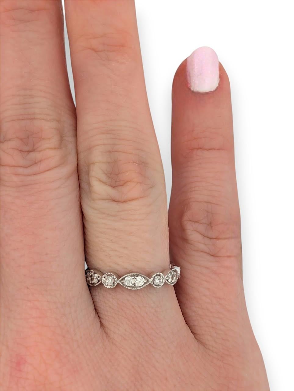The Hope 14k White Gold Ring is a stunning blend of artistry and elegance, featuring a unique decorative design with alternating shapes adorned with .45 carats of natural round diamonds. This ring offers a fresh twist on a classic band, combining