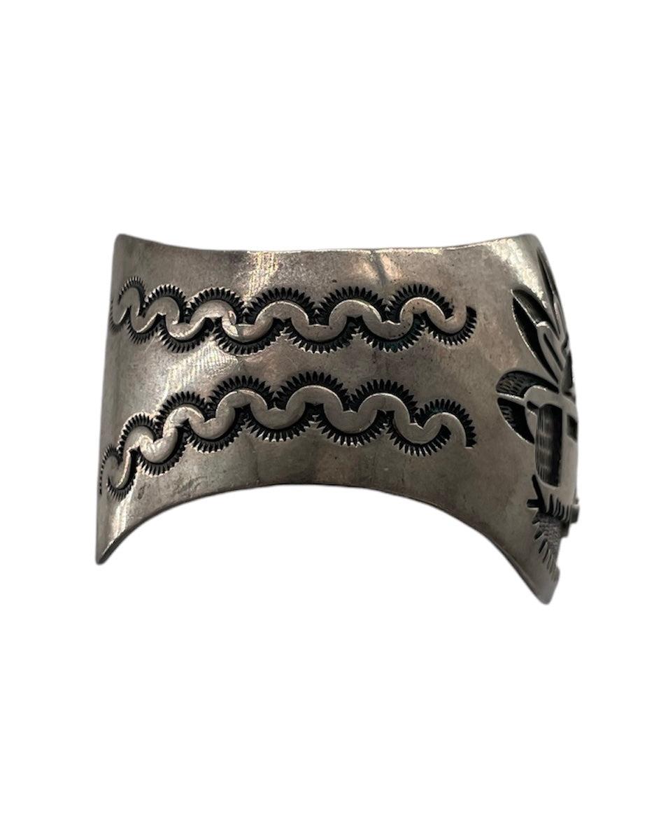 Hopi Kachina Cuff, semi adjustable with pressure to bend or open cuff. Sterling silver . No signature.

Additional information:
Dimensions: Opening at rest is 1.5