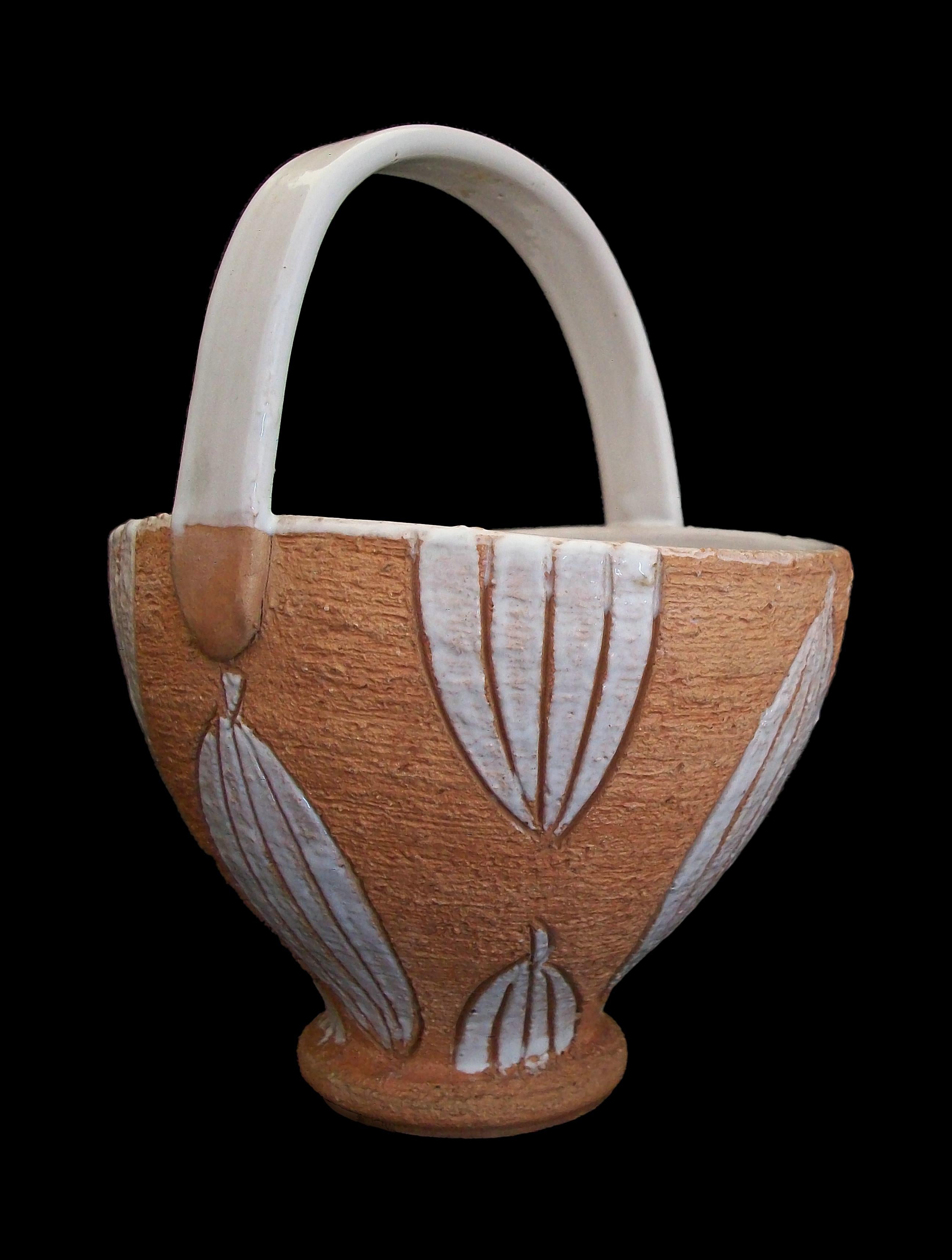 HORIZON - Mid Century studio pottery basket / bowl / vase with white glazed handle and interior - hand made - featuring incised and white glazed leaves to the exterior of the bowl - unglazed textured finish to the exterior - original paper label