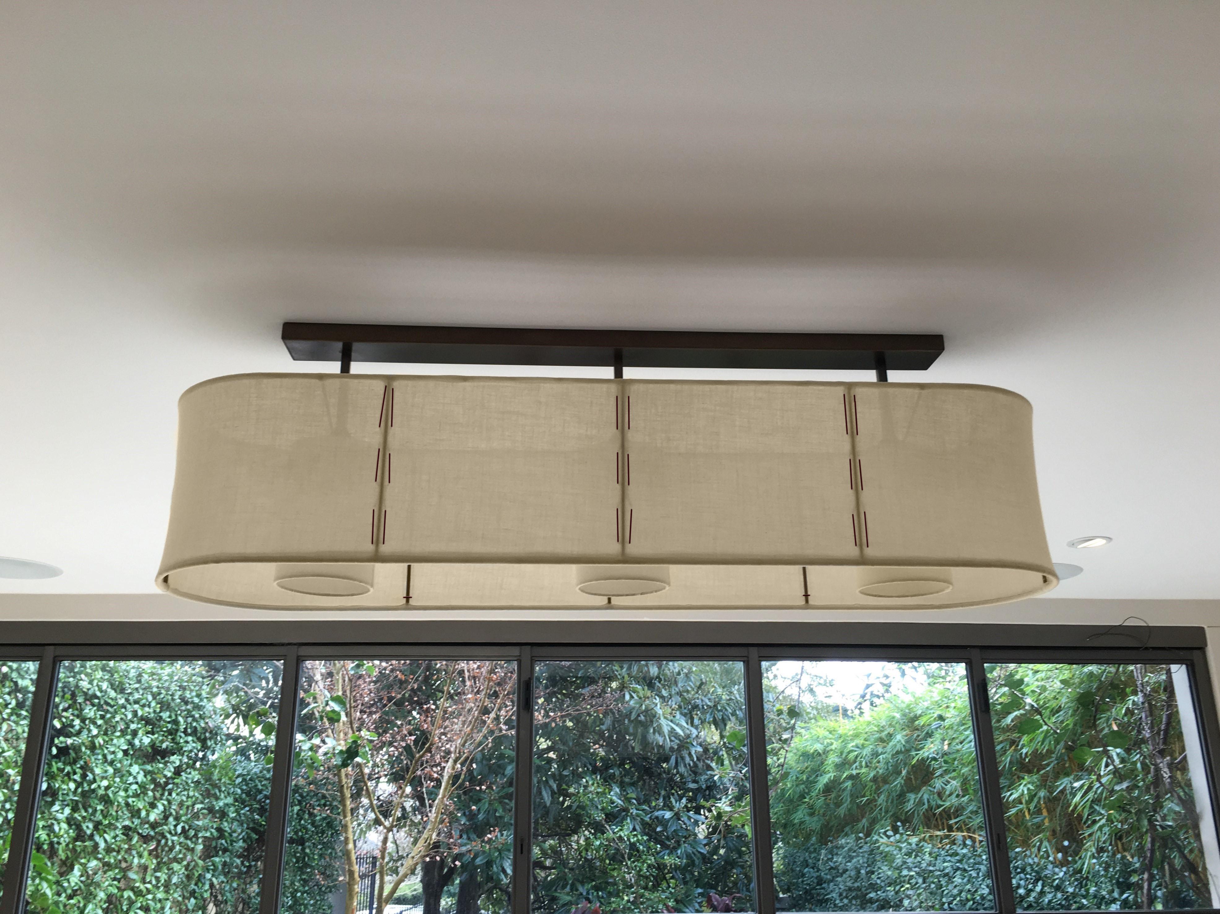 Horizon Pendant is a minimal, elegant, versatile, flush mount or suspended 3 light pendant. This subtle minimal statement light is designed and handcrafted one piece at a time in Australia of fine translucent Italian linen and patinated brass.