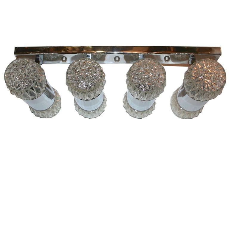 An Italian chrome-plated 8 light fixture with molded glass insets. The fixture suspended from 2 rods, but could be mounted as flush mounted.