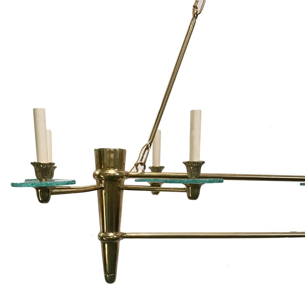 A circa 1960's French Moderne gilt metal horizontal body chandelier with eight lights.

Measurements:
Length: 48