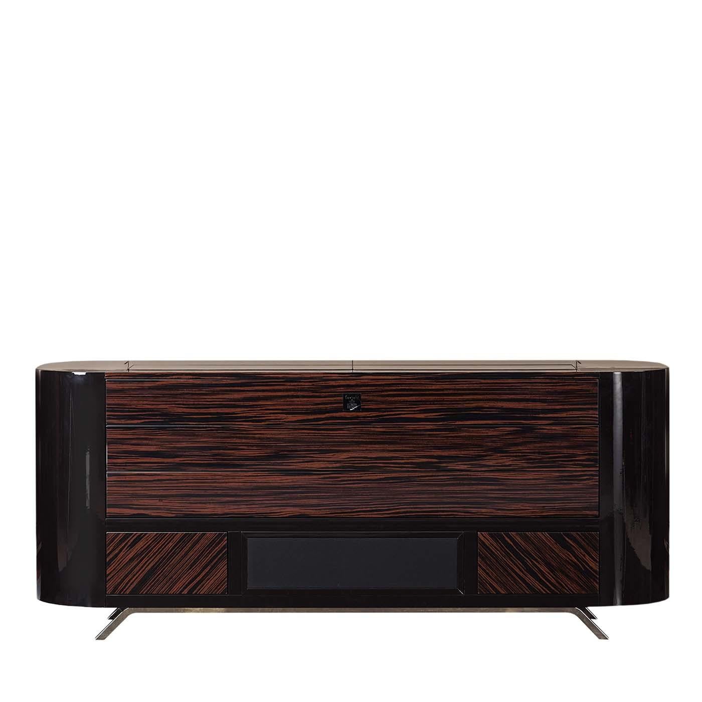 This elegant sideboard in glossy Makassar ebony, dedicated to the world of billiard and cigars, presents prestigious solutions both in manufacturing and design. It is equipped with compartments, drawers, a Bose minimal soundbar system, a multimedia