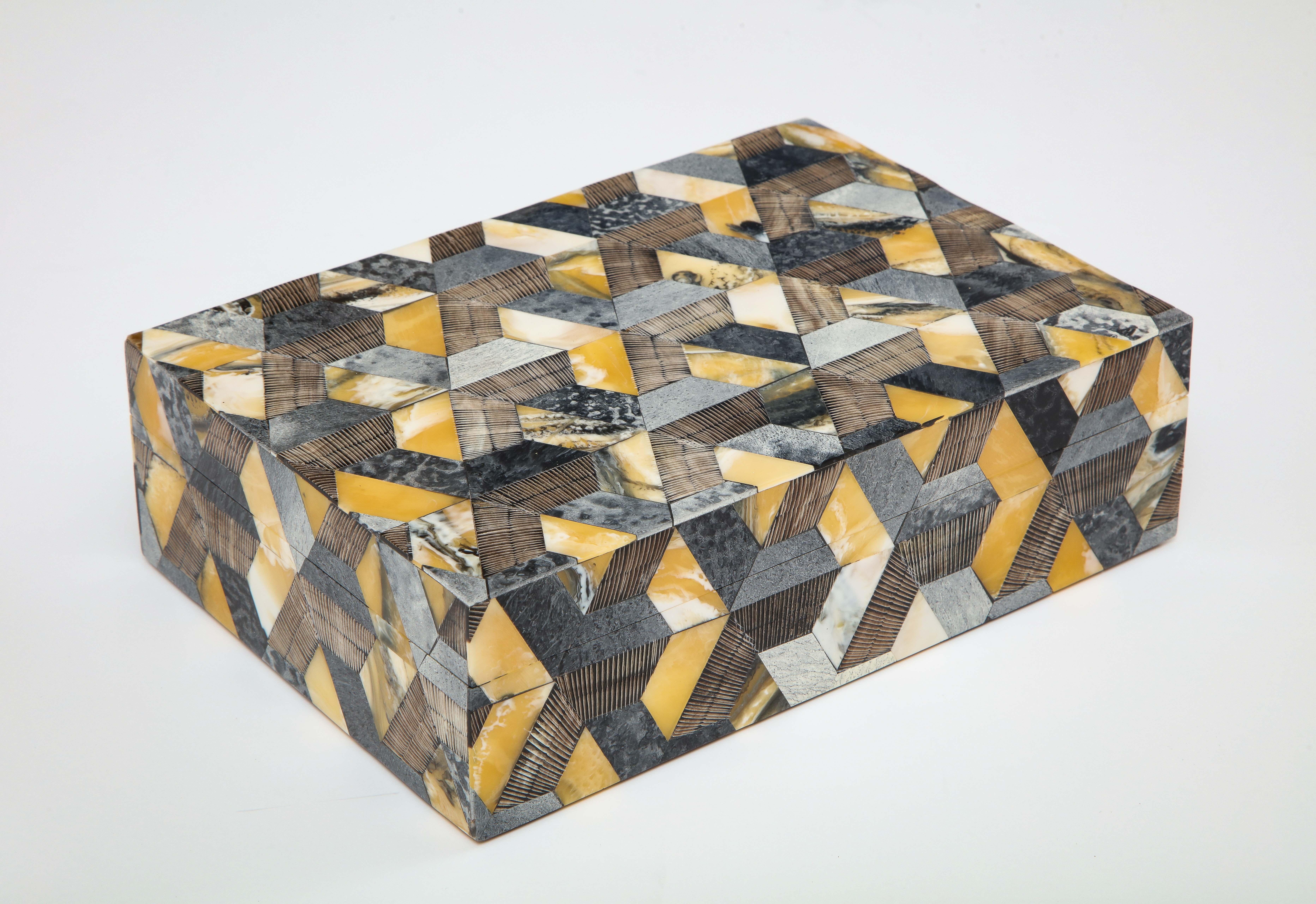 Decorative keepsake box with a mosaic graphic pattern made from natural horn and bone tiles, some with hand incised pattern, lined in wood.
