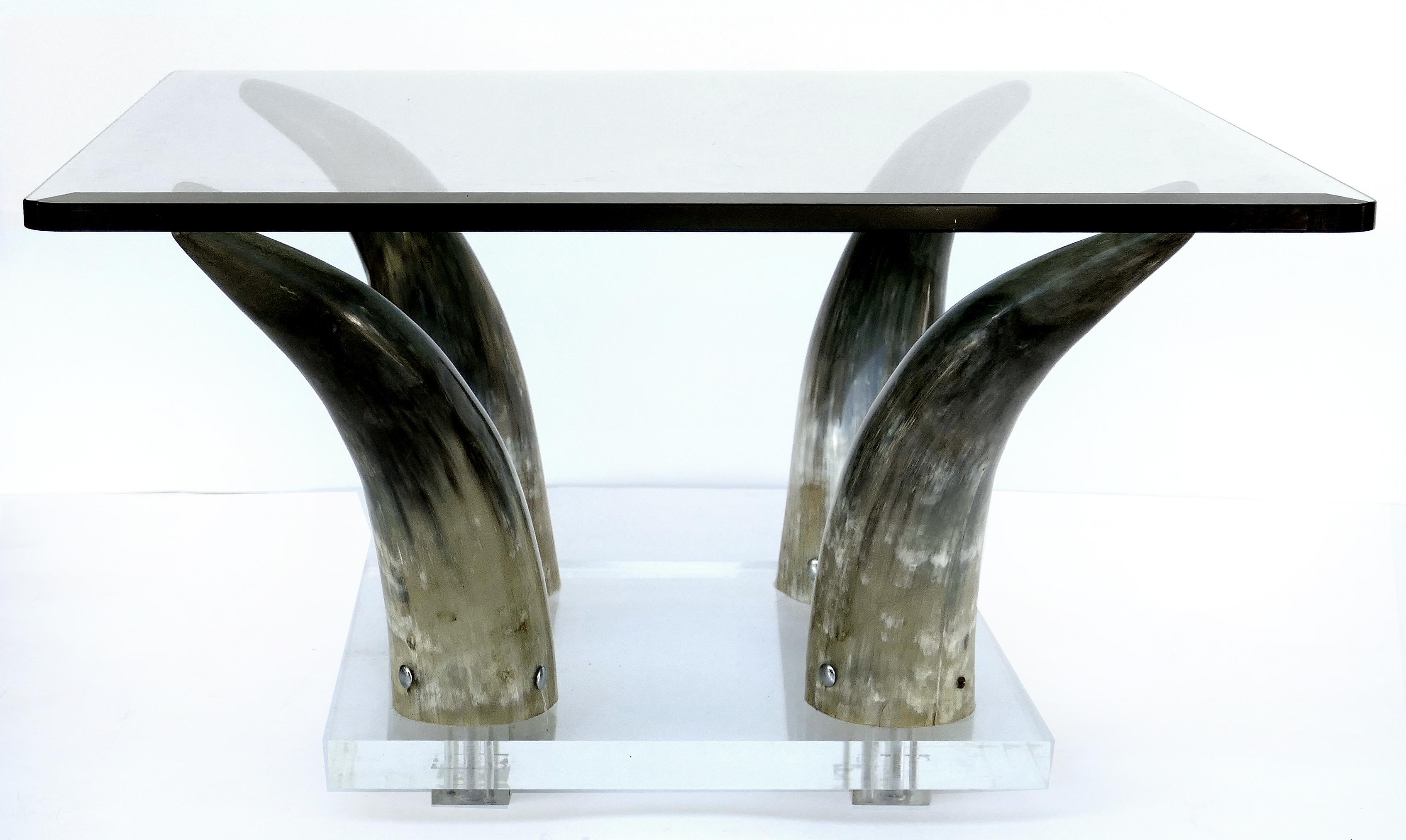 Horn and Lucite coffee table or low side table with glass top

Offered for sale is a modern polish steer horn and Lucite coffee table or low side table. Four horns are raised on a Lucite base to support a beveled glass top.