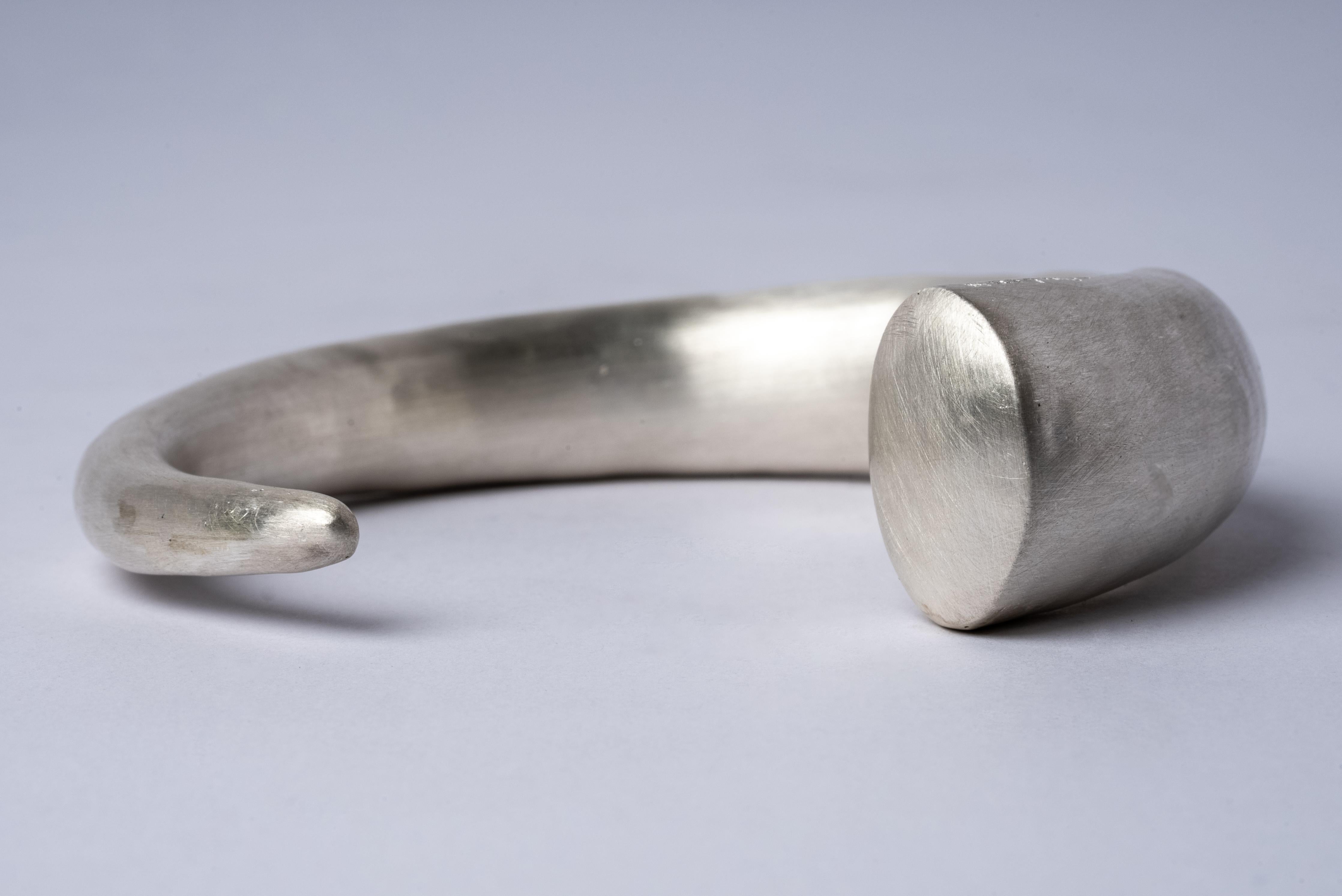 Horn bracelet in matte sterling silver. This piece is 100% hand fabricated from metal plate; cut into sections and soldered together to make the hollow three dimensional form. If sterling silver, the sheet metal is made by hand. The silver is melted