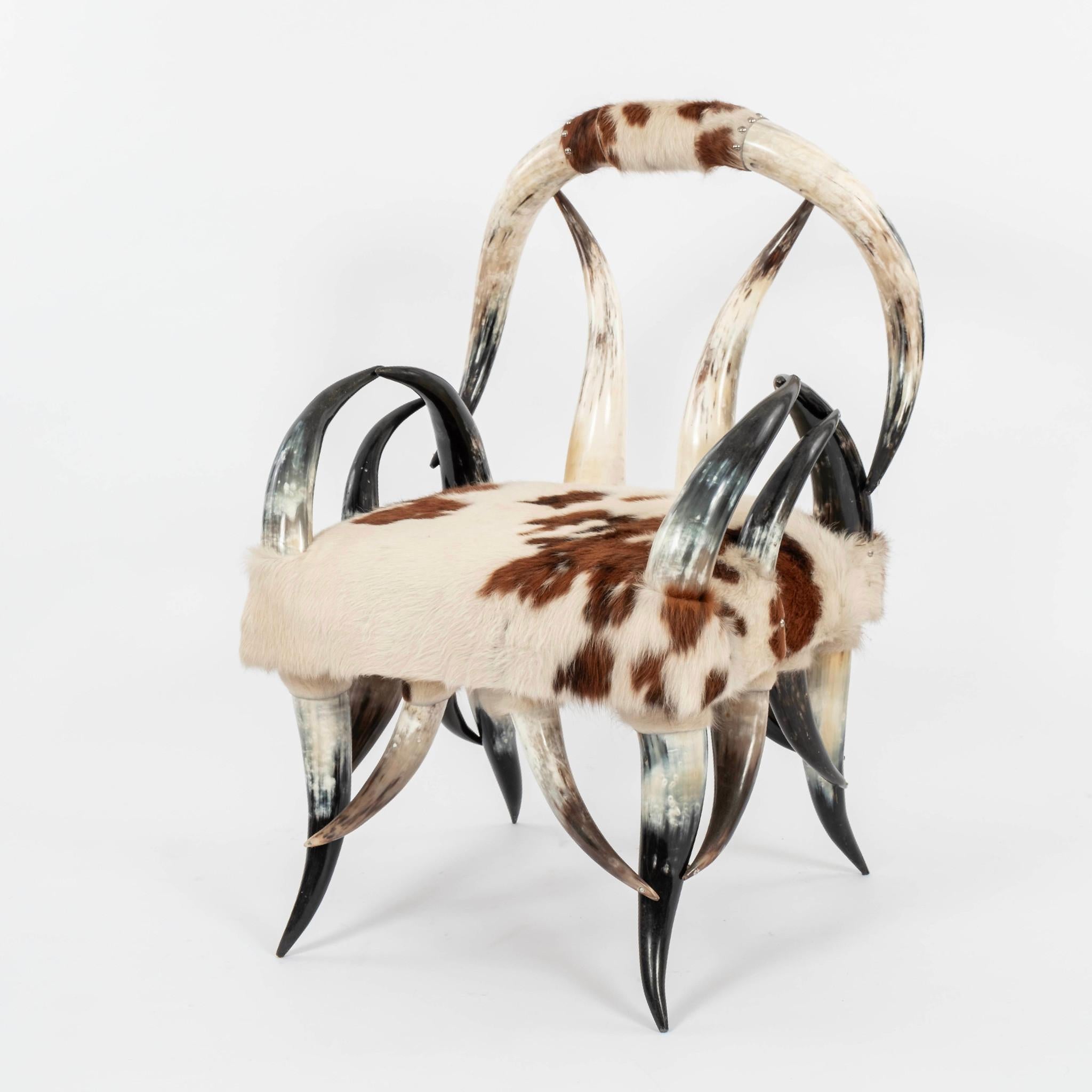 21st Century horn chair upholstered in a brown and white cowhide.
