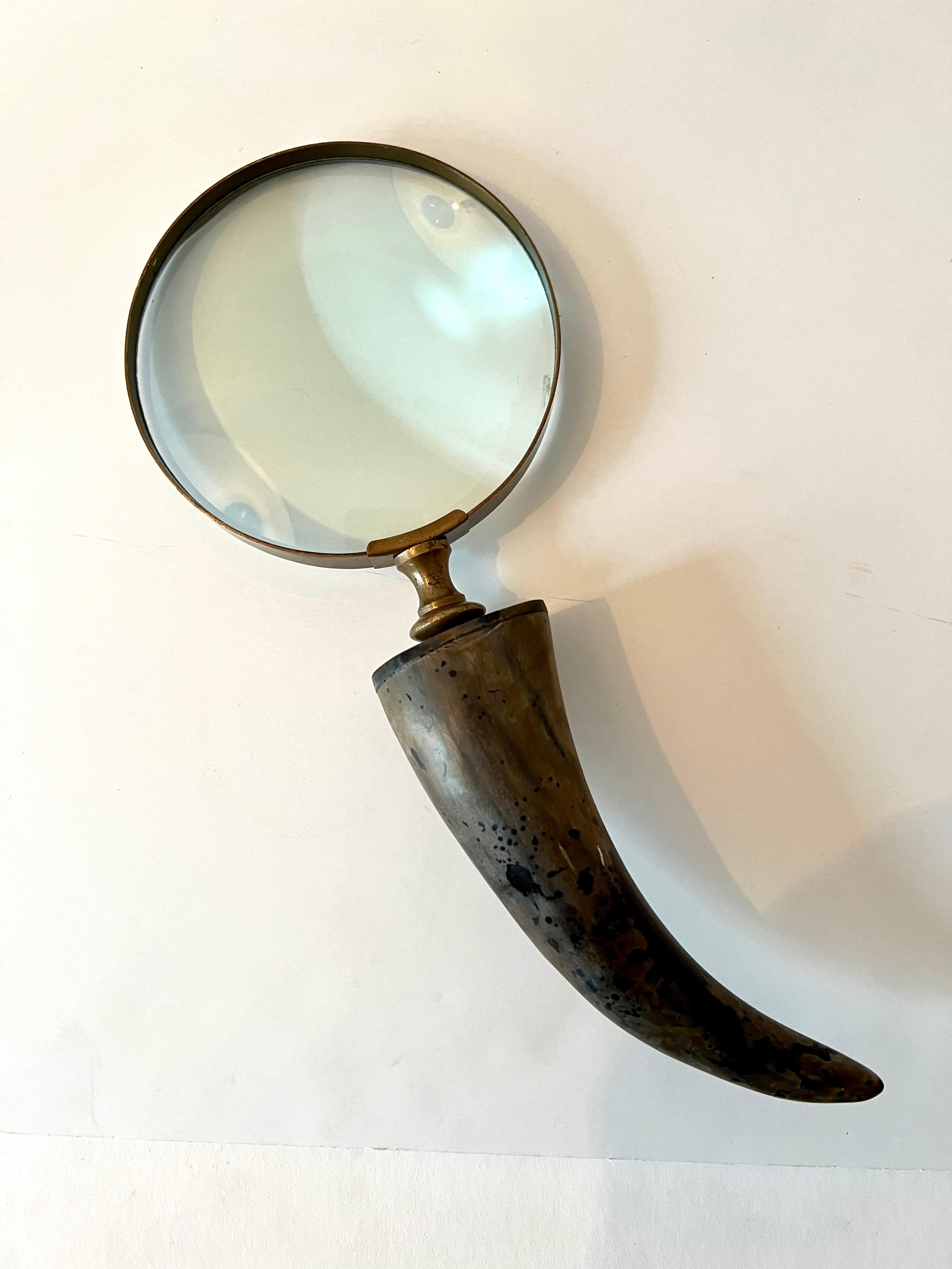 Horn Handle desk style magnifying glass with brass framework and stem. 

A compliment to any desk or work station, especially those in a Ralph Laurent or more rustic setting, but could also easily work in a modern and architectural environment.