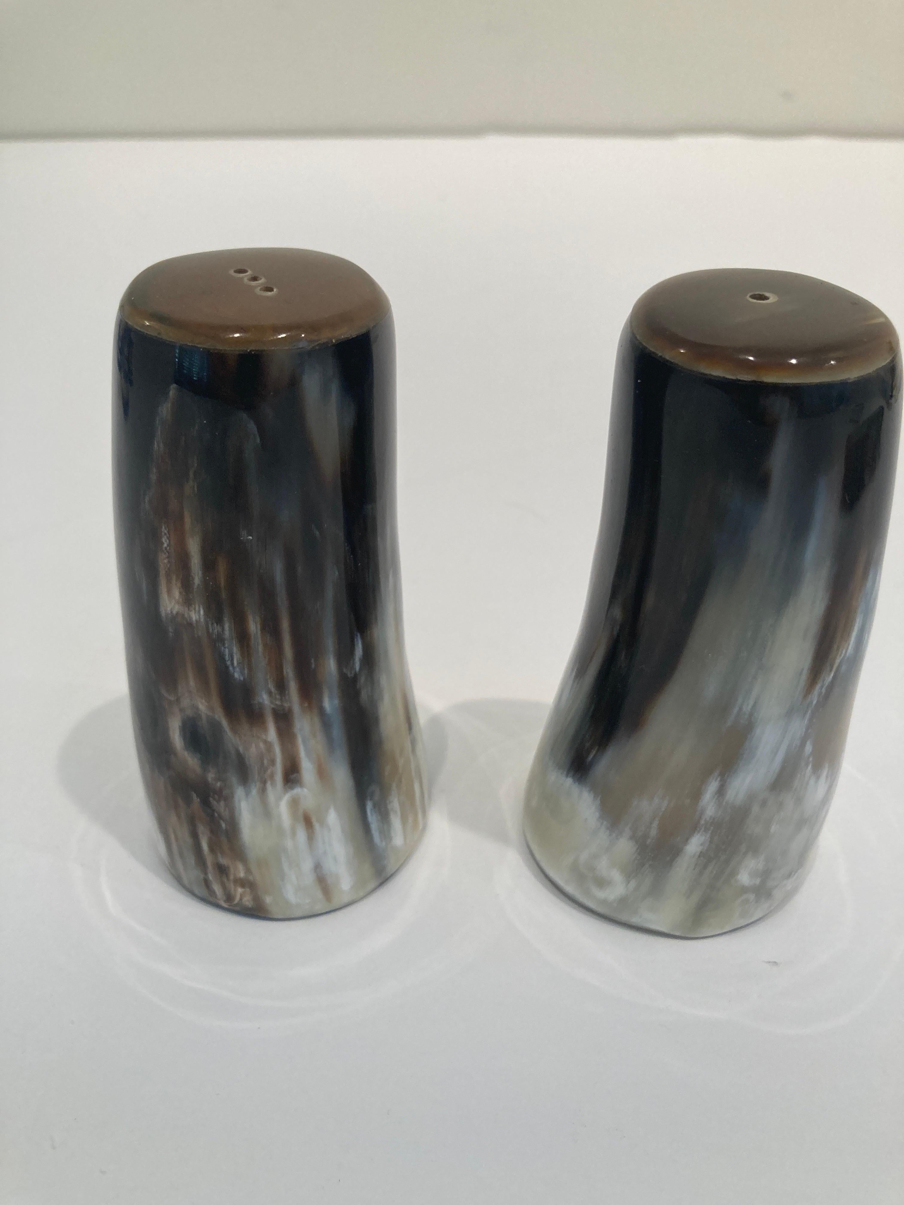 Vintage Set of two salt and pepper shakers showcasing the natural beauty of water buffalo horn. Using sustainable and traditional practices, handcrafted by skilled artisans in India. 
These natural horn Salt and Pepper Shaker Set will add an