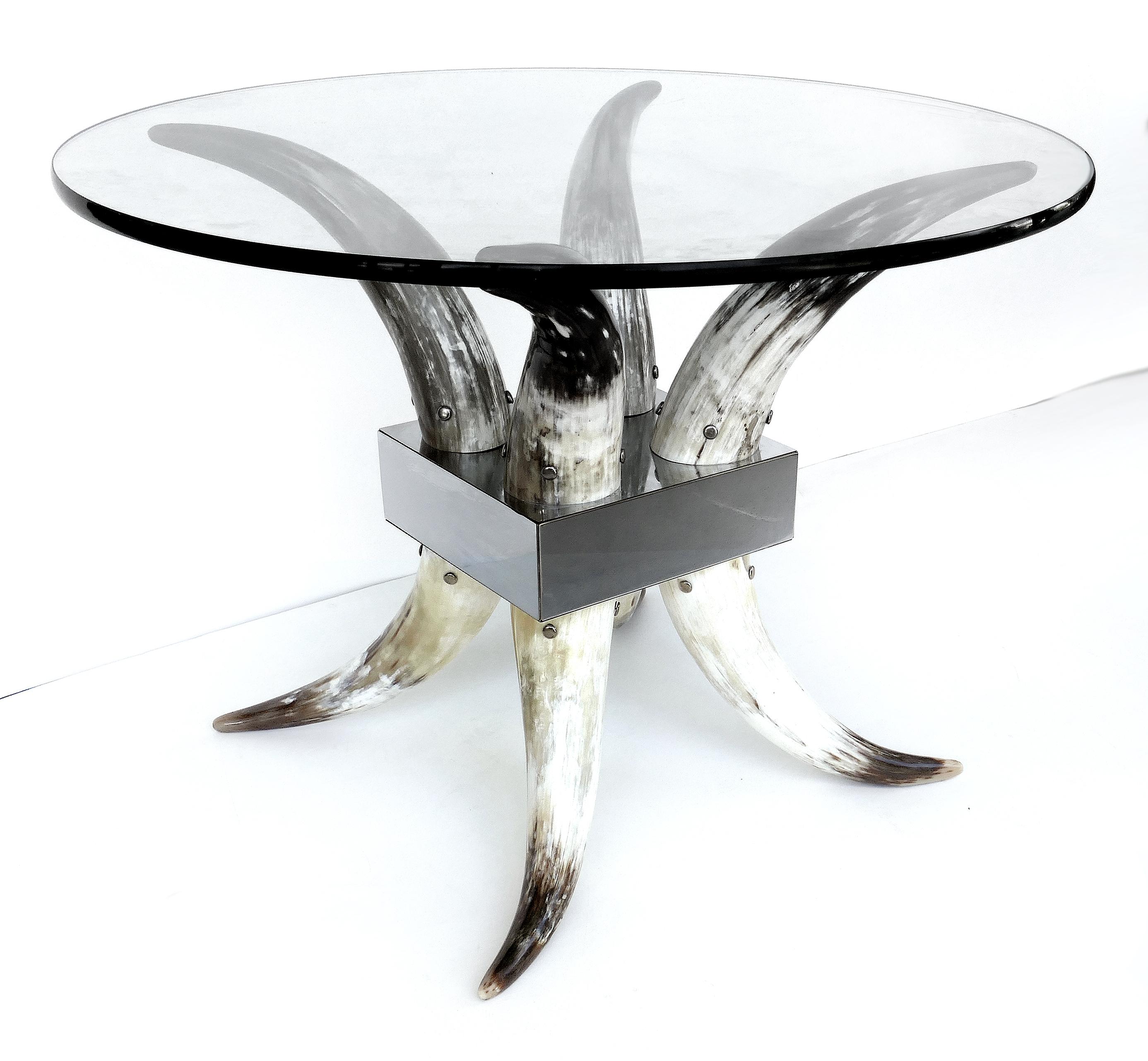 Offered for sale is an elegant modern steer horn, stainless steel and glass center table. This table can support a 60