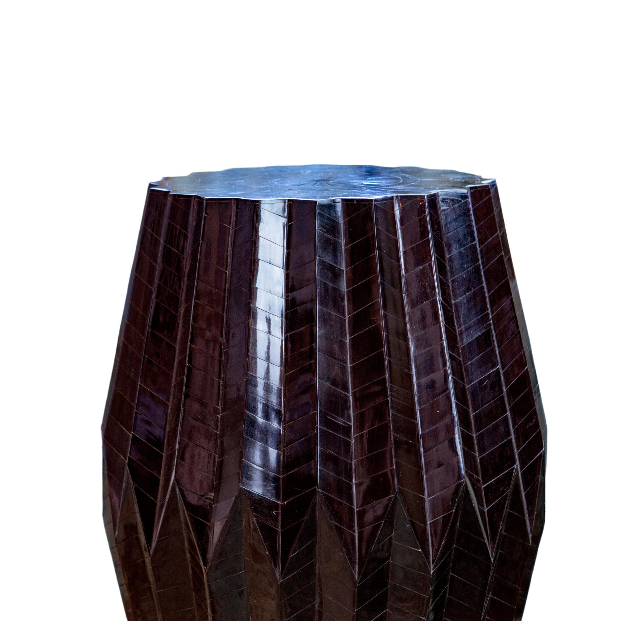 Resembling its namesake, the Tabla which is an Indian percussion drum, this end table flaunts a sculptural form. Thus Award winning table is made with a wood base and topped with angular bone chips to create a tonal pattern on a rhythmic form. The