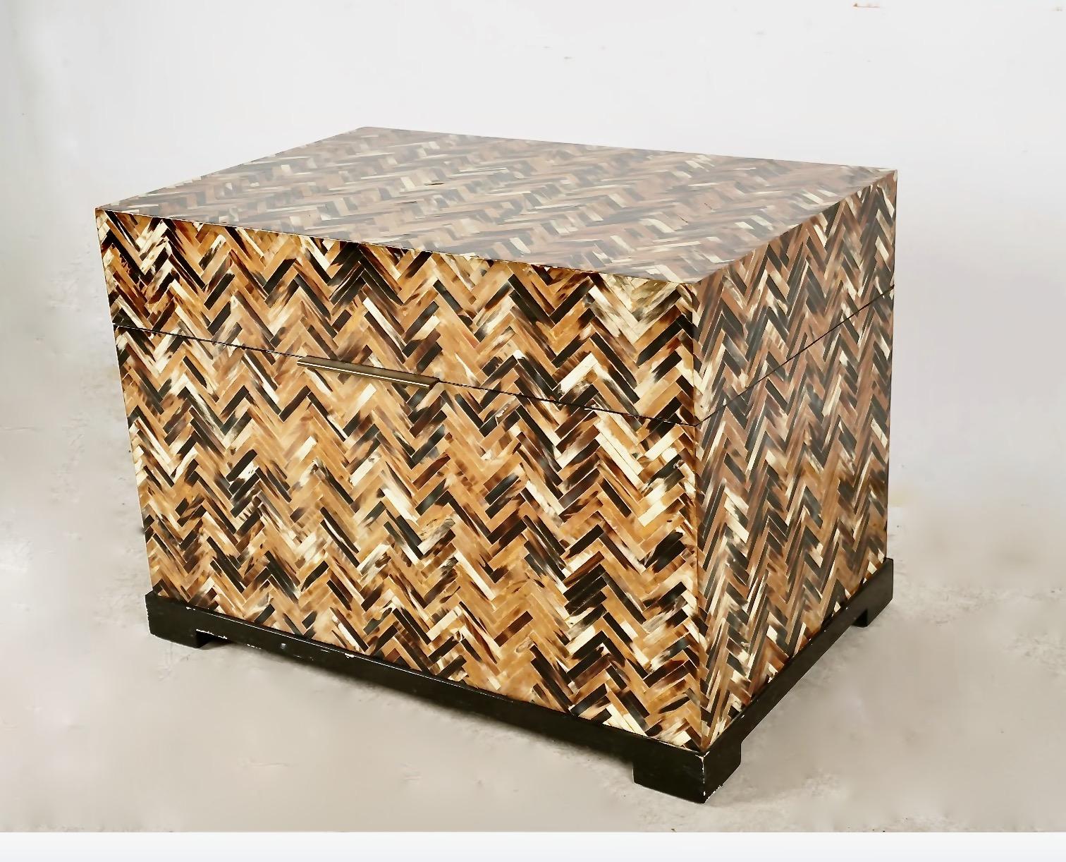 This is an eye-catching late 20th century small trunk or chest that has been meticulously veneer in horn in a chevron parquetry style. The chest is in overall good condition with minor patination.