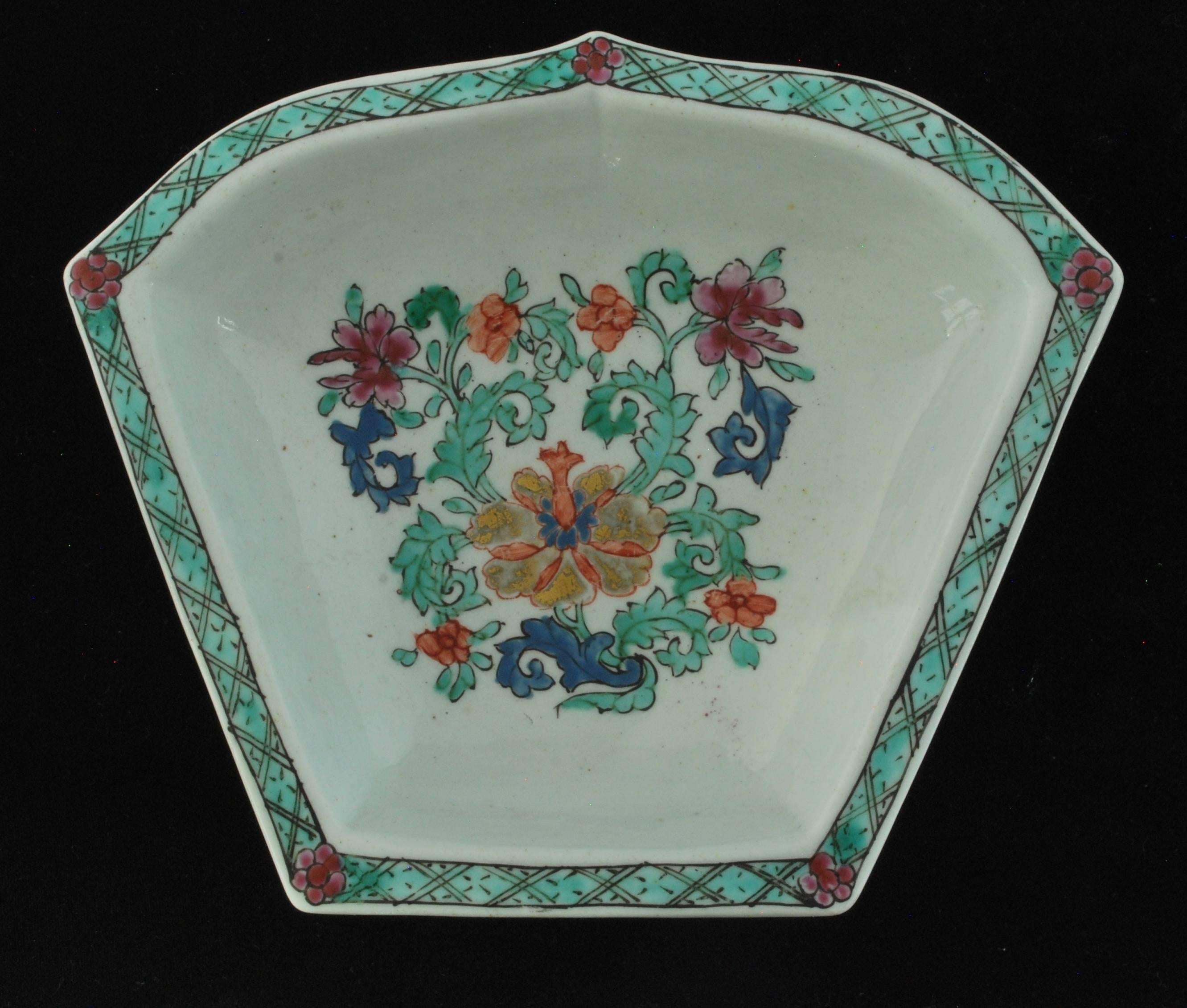 Ogival petal form with flat rim. Enamelled in colors and gilt with flowers and leaves, after the Chinese; using turquoise to emulate the Famille Verte palette. Presumably one leaf from a Bow set of eight ‘petal’ dishes and a conforming central