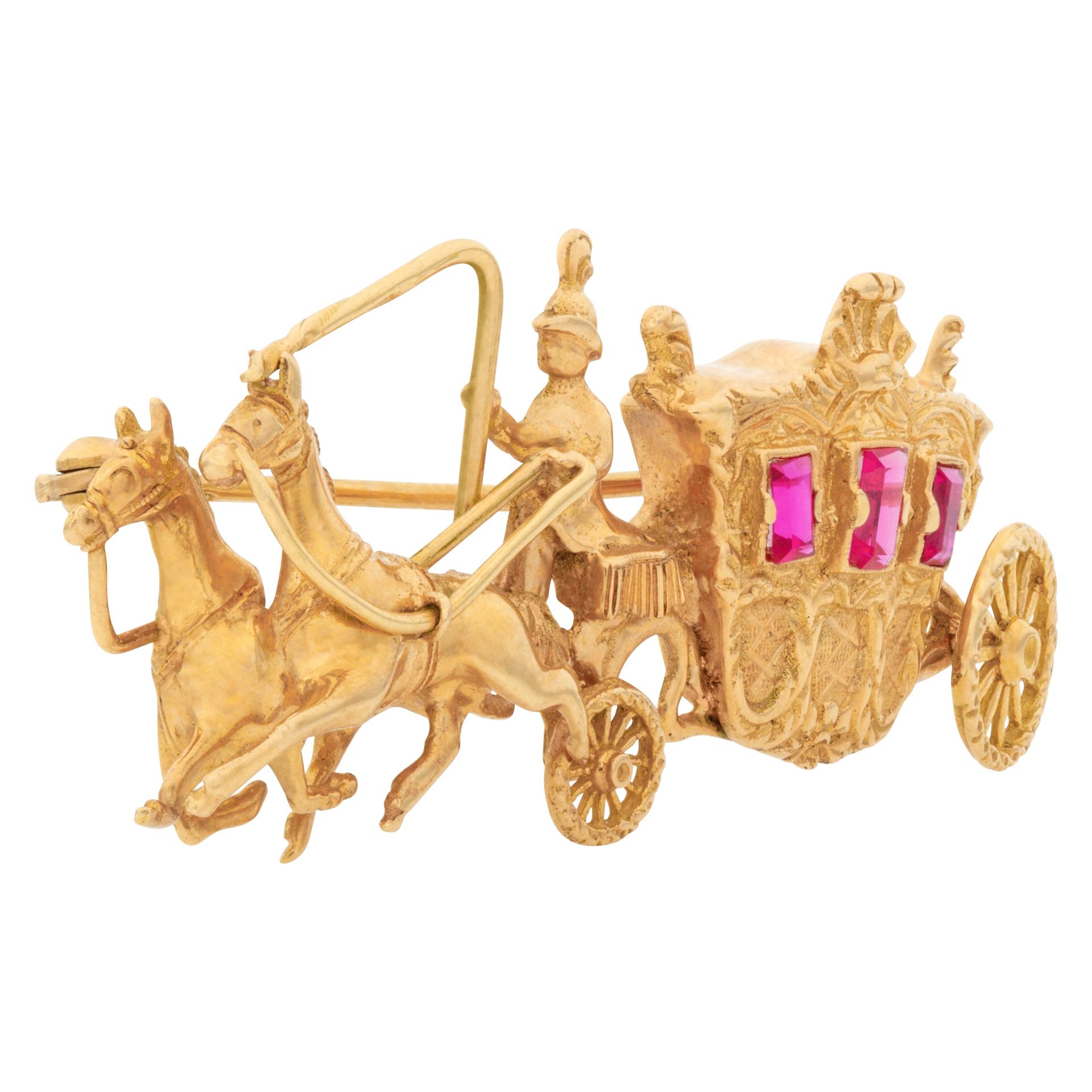 Beautiful horse & carriage broach with rubies windows set in 18k yellow gold. Broach measures 2.3'' width,  1'' length.
