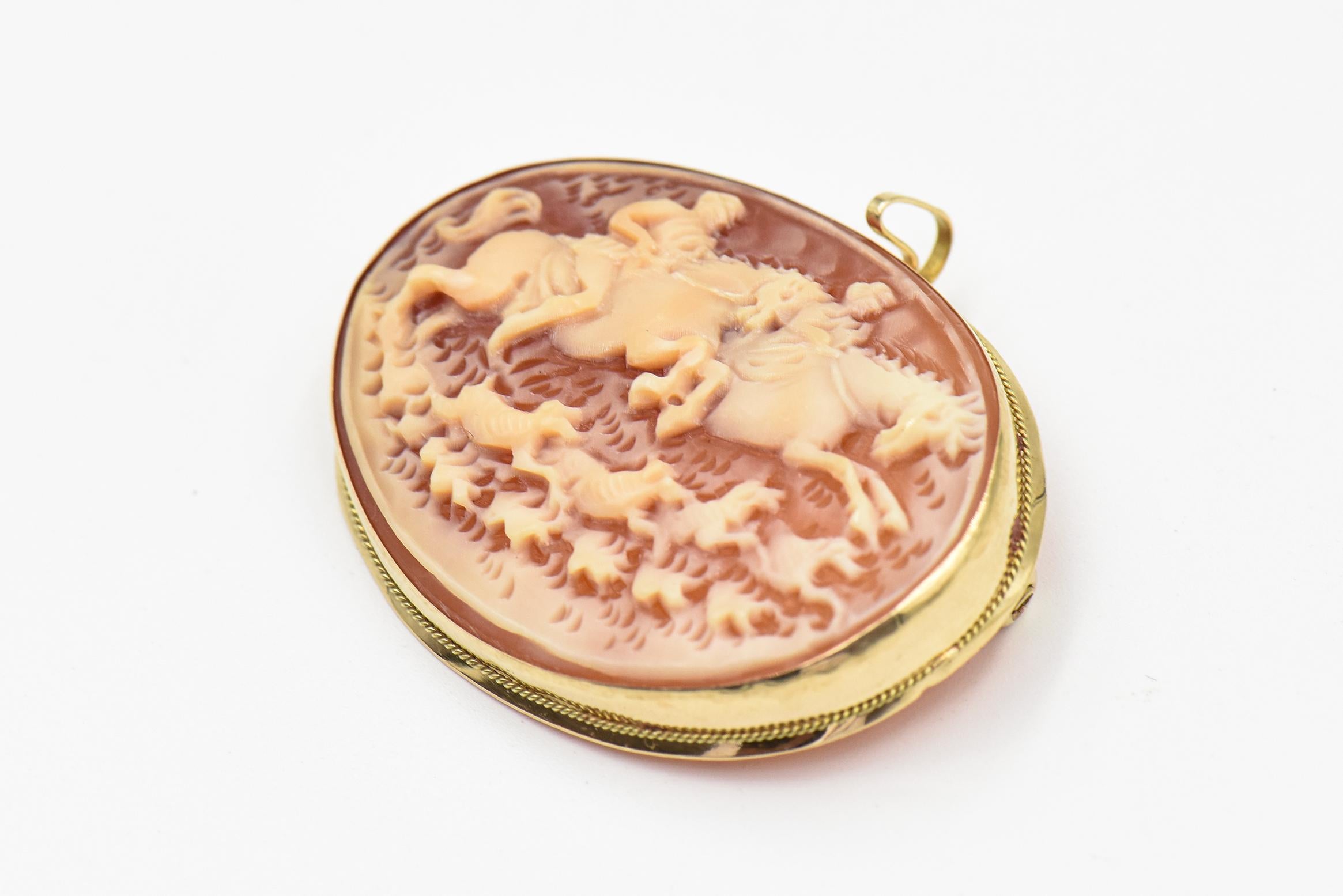 Hunt scene shell cameo signed Borriello for (Italian Gennaro Borriello) on the back mounted in a 14k yellow gold frame.  The scene has two people galloping on horses with 4 dogs running besides them.  

For the past 50 years, Borriello has gained