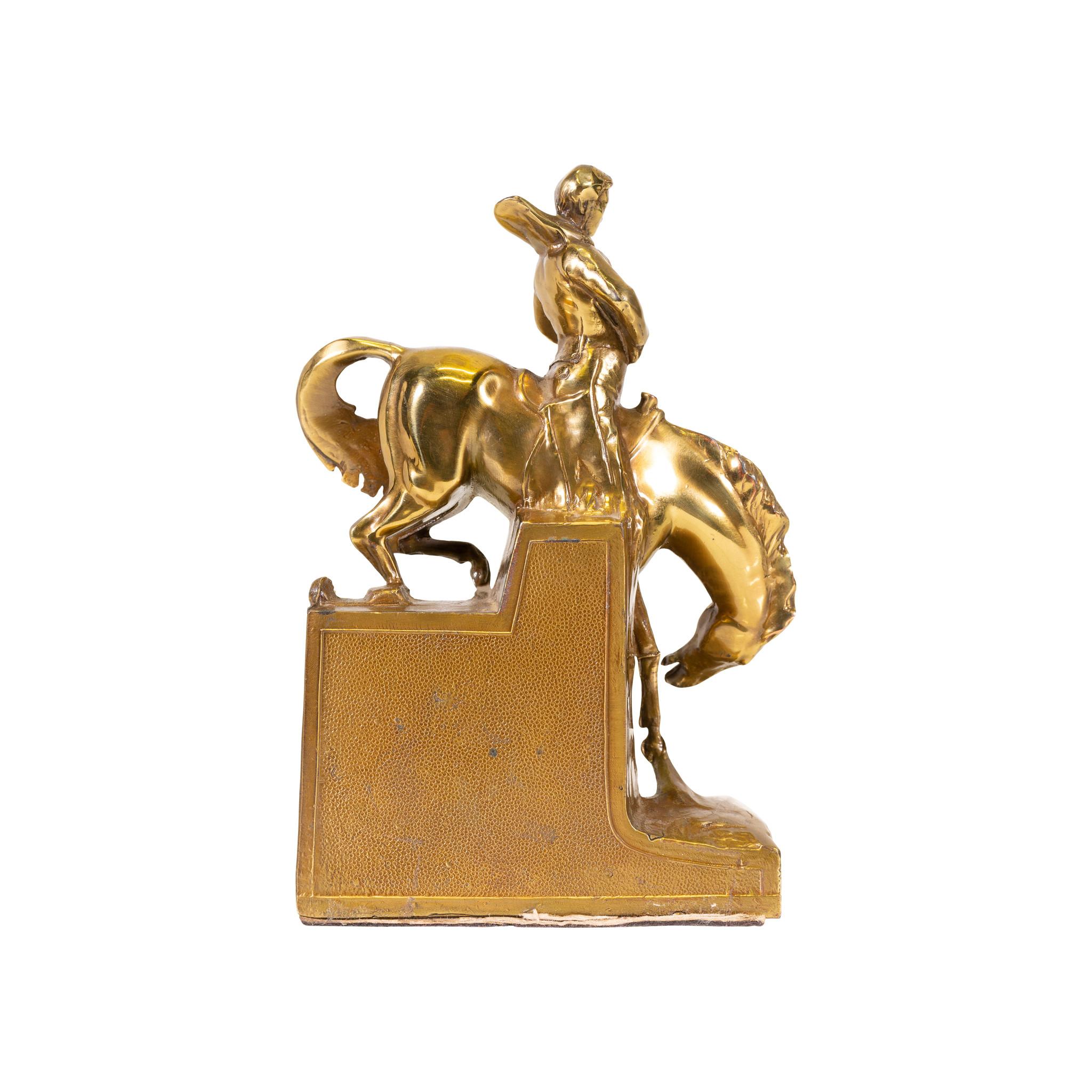 Let 'Er Buck - matched pair of Let 'Er buck bookends. Solid cast bronze with patina finish. Made by PM craftsmen. Cowboys riding bucking horses. Great for any office, bookshelf or western setting.

Origin: United States
Period: First quarter of the
