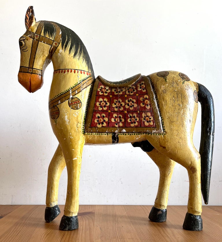 Beautiful hand-painted wooden horse dating back to the early 1900s in perfect arts & craft style with lack of color that increases the beauty of the object.